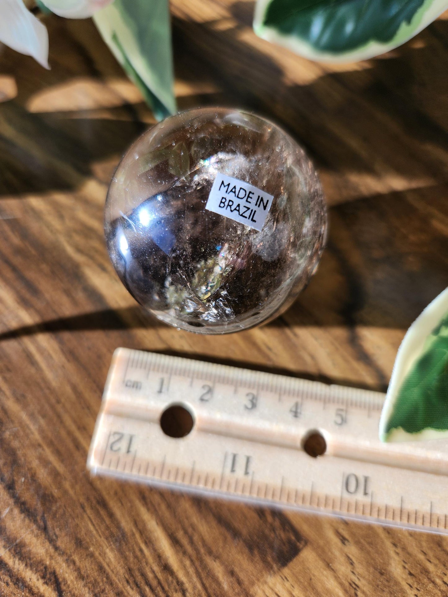 High quality natural smoky quartz sphere with many rainbows and inclusions