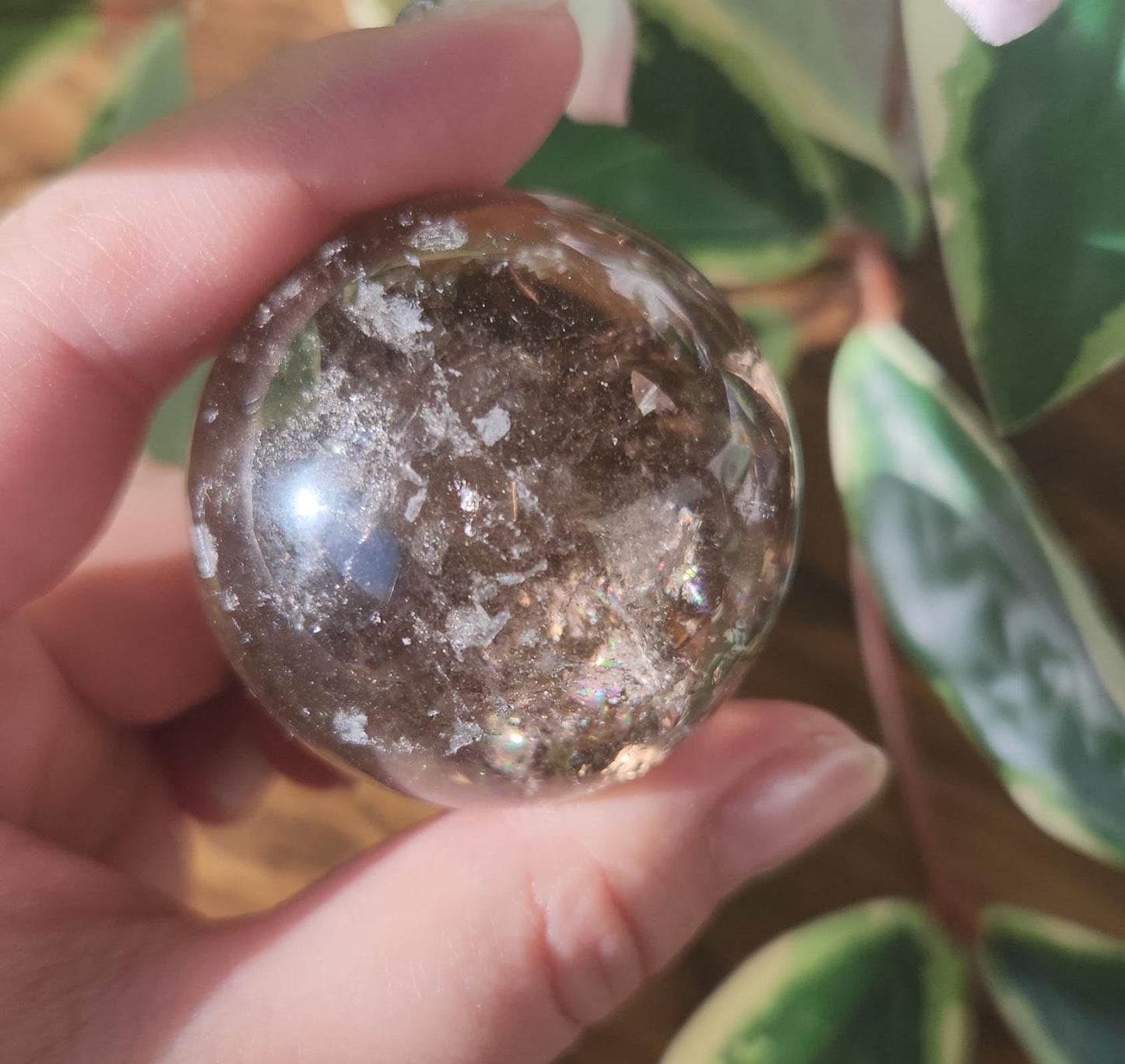 High quality natural smoky quartz sphere with many rainbows and inclusions