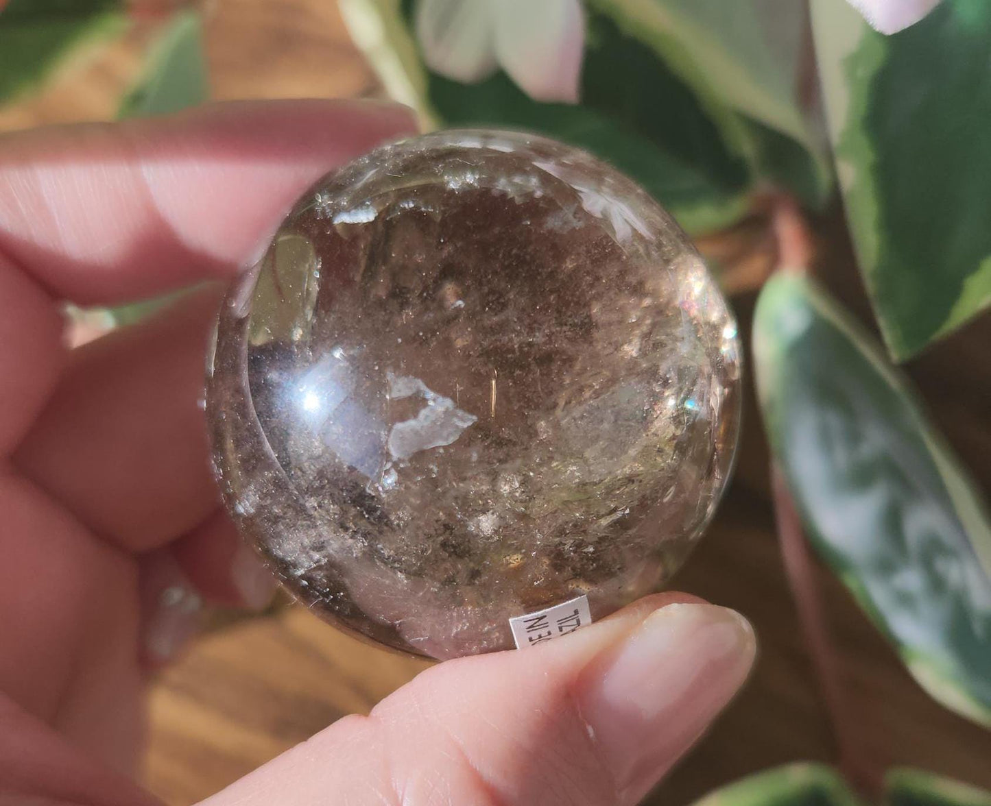 High quality natural smoky quartz sphere with many rainbows and inclusions