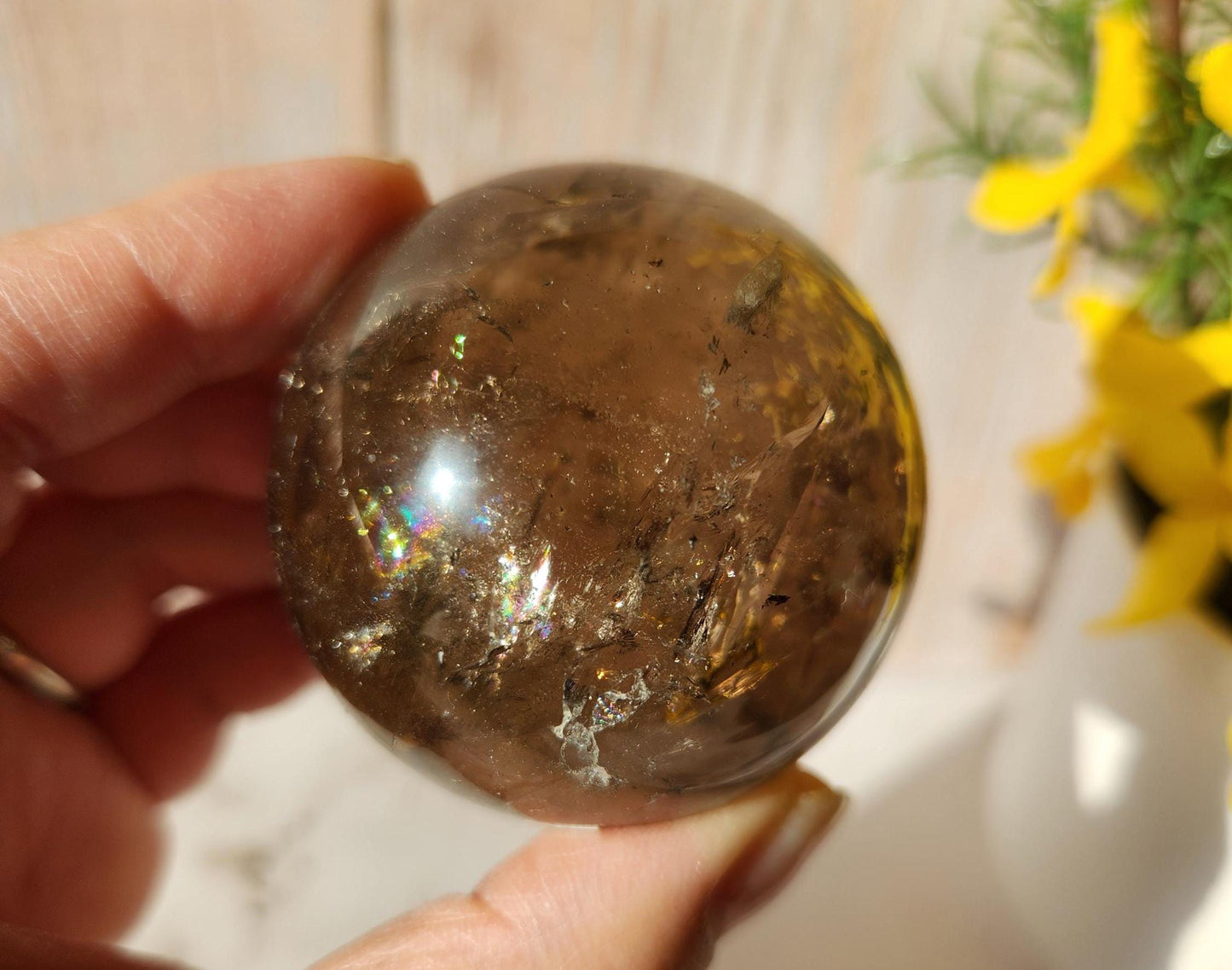 Stunning natural dark smoky quartz sphere with many rainbows and inclusions