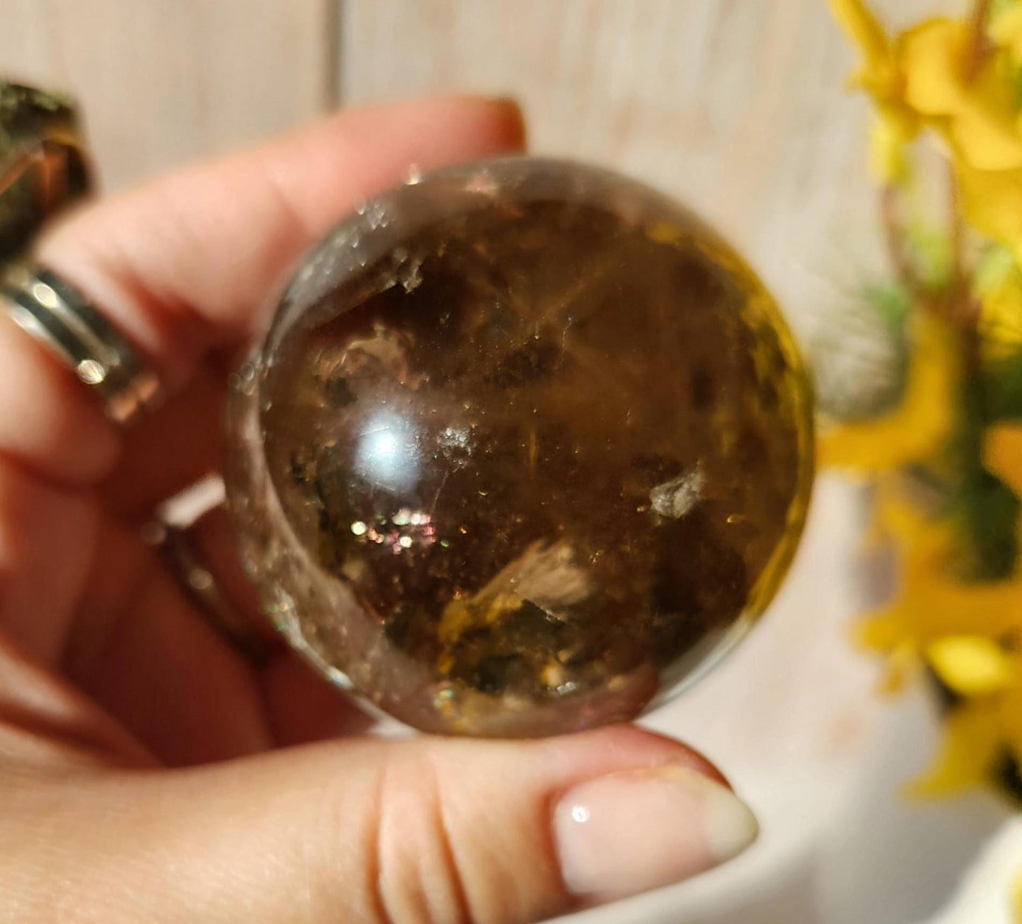 Stunning natural dark smoky quartz sphere with many rainbows and inclusions