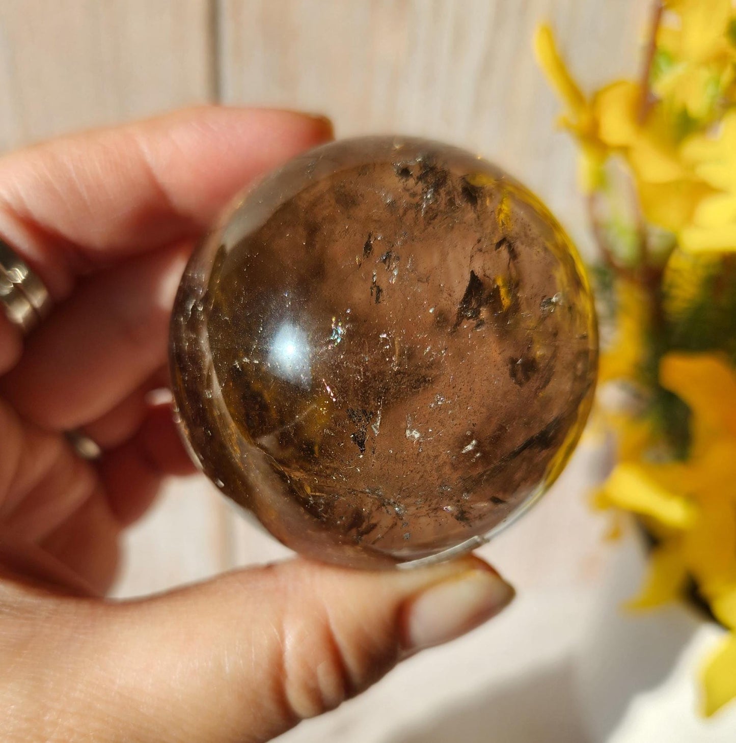 Stunning natural dark smoky quartz sphere with many rainbows and inclusions