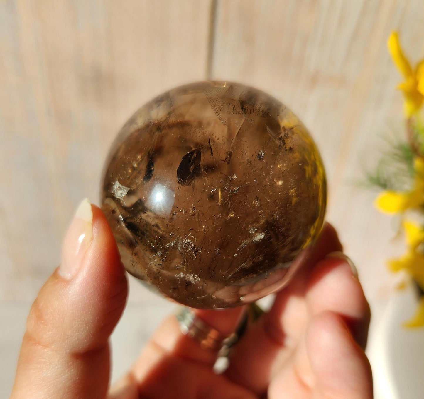 Stunning natural dark smoky quartz sphere with many rainbows and inclusions
