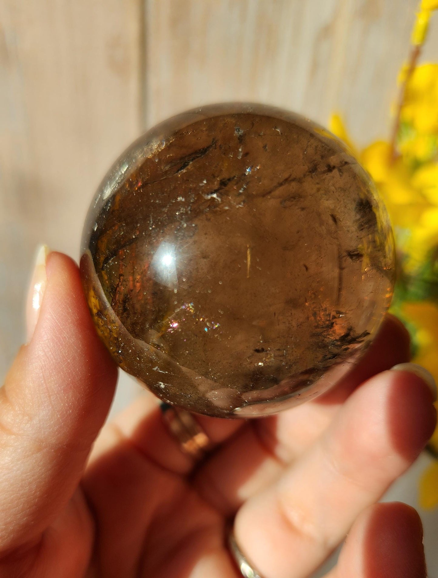 Stunning natural dark smoky quartz sphere with many rainbows and inclusions