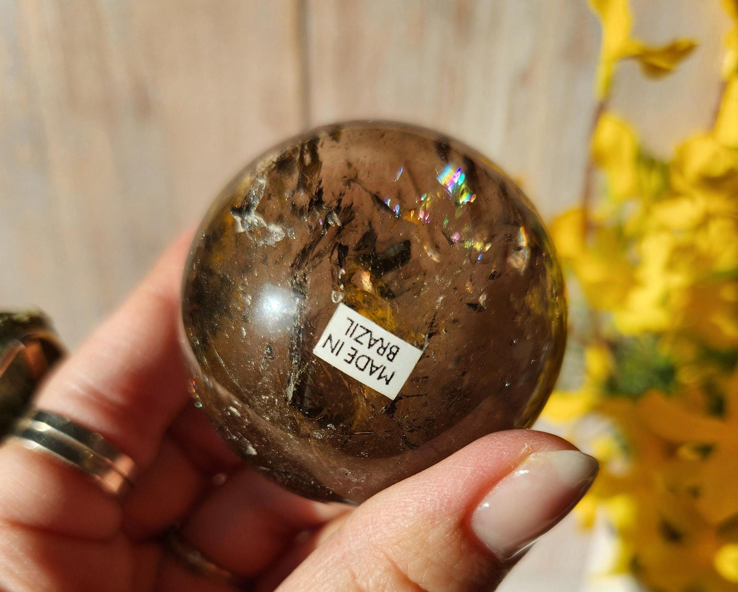 Stunning natural dark smoky quartz sphere with many rainbows and inclusions
