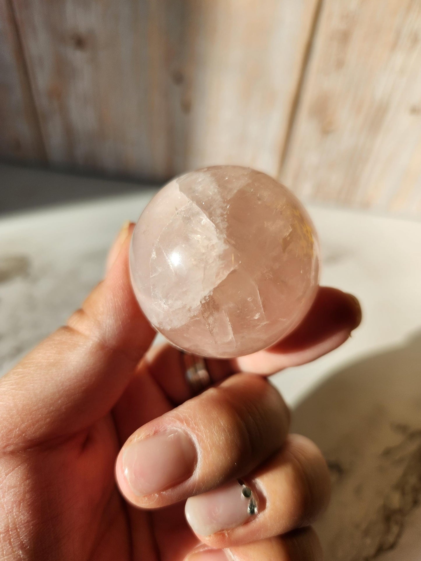Juicy rose quartz sphere with inclusions, rainbows, and asterism from Brazil 38.5mm