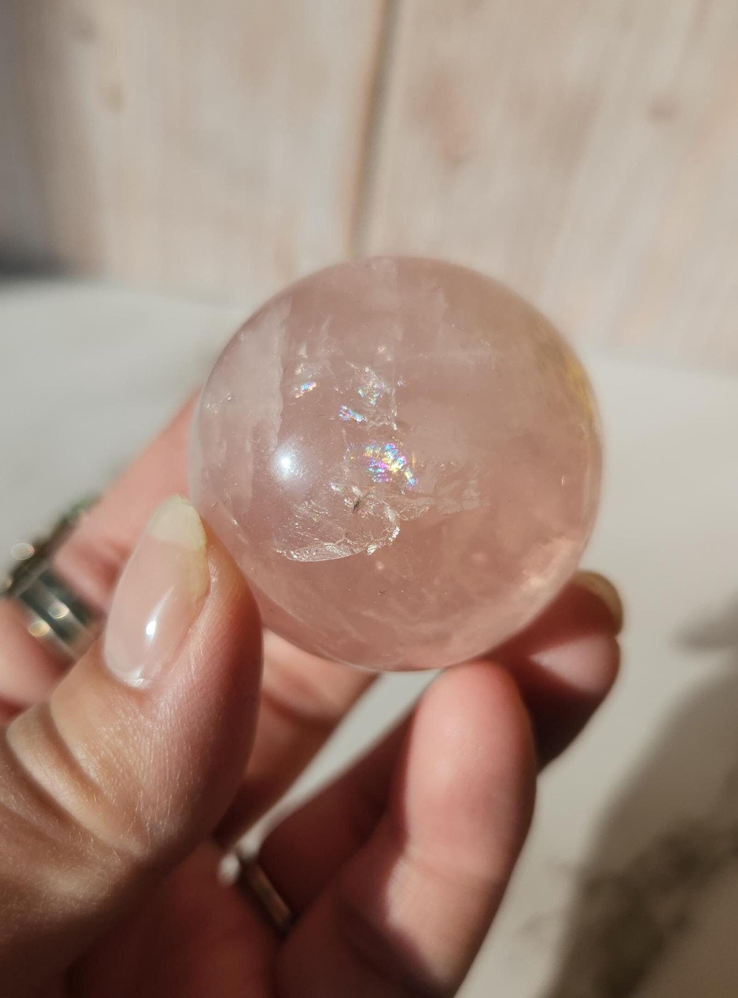 Juicy rose quartz sphere with inclusions, rainbows, and asterism from Brazil 38.5mm