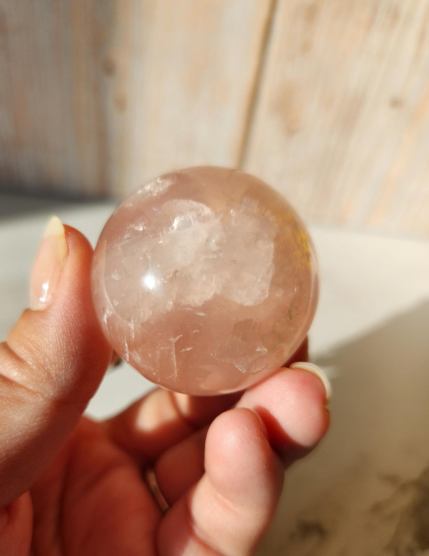 Juicy rose quartz sphere with inclusions, rainbows, and asterism from Brazil 38.5mm