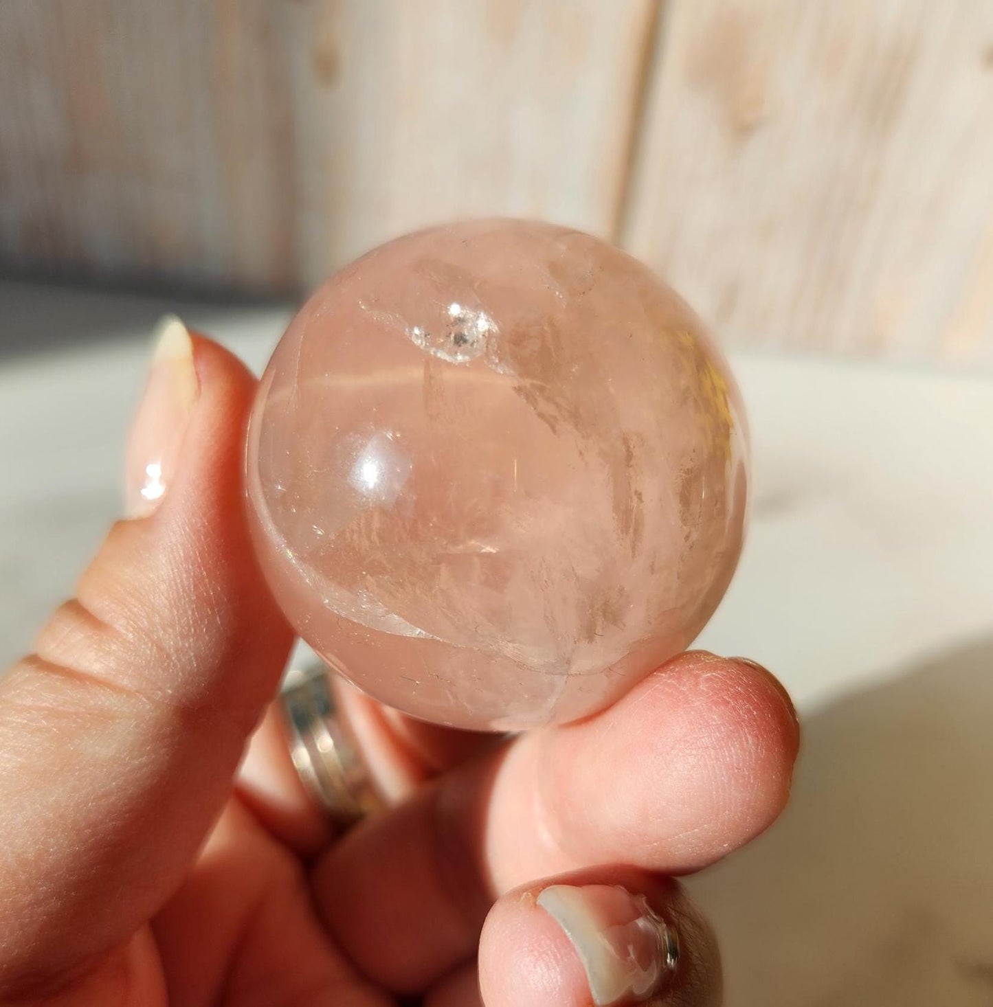 Juicy rose quartz sphere with inclusions, rainbows, and asterism from Brazil 38.5mm