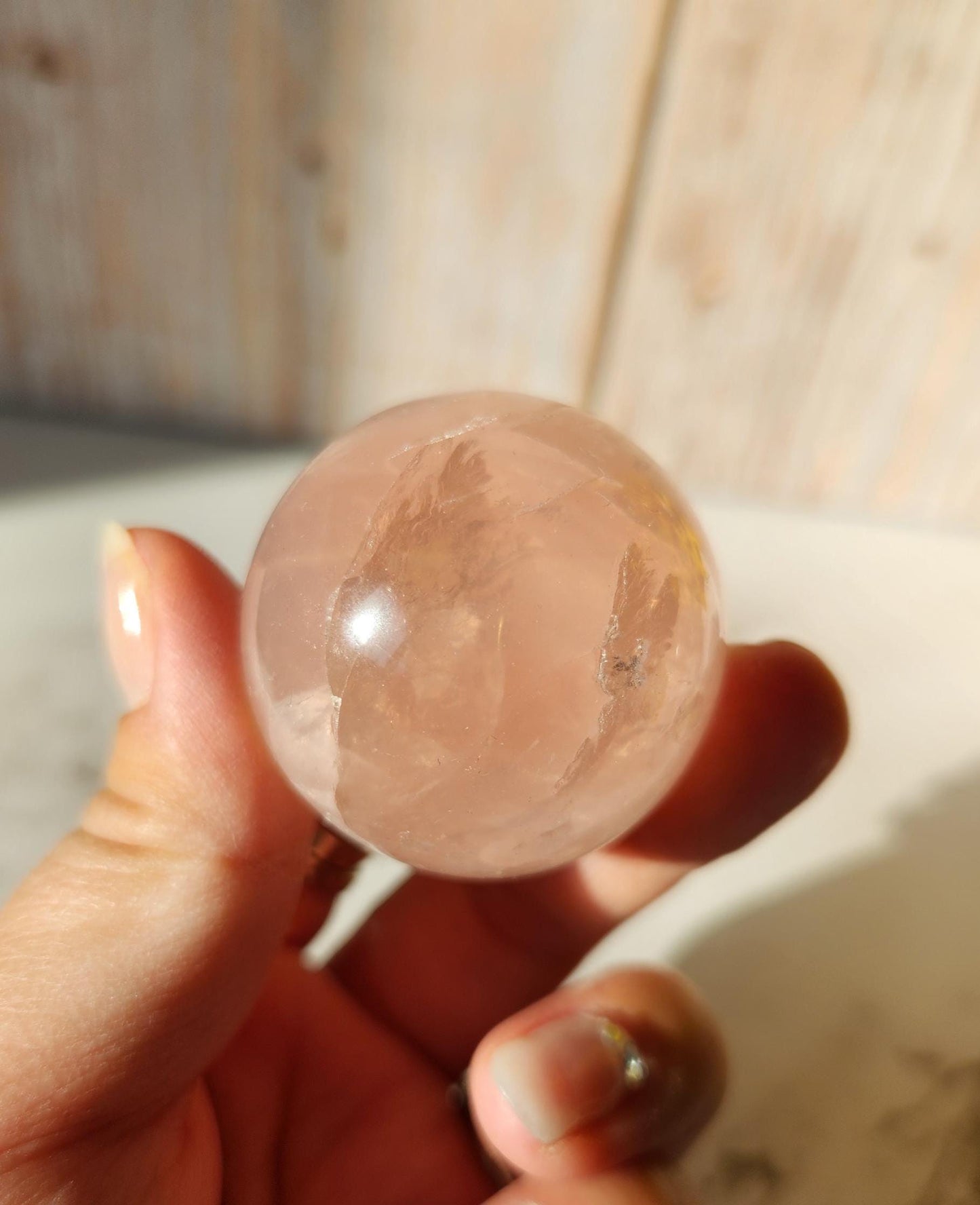 Juicy rose quartz sphere with inclusions, rainbows, and asterism from Brazil 38.5mm