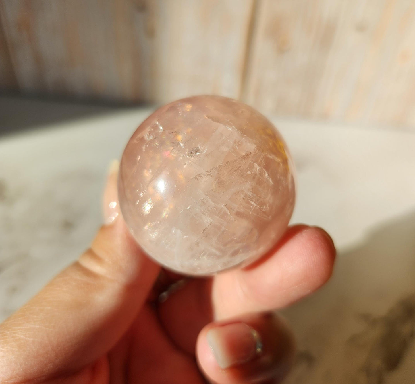 Juicy rose quartz sphere with inclusions, rainbows, and asterism from Brazil 38.5mm