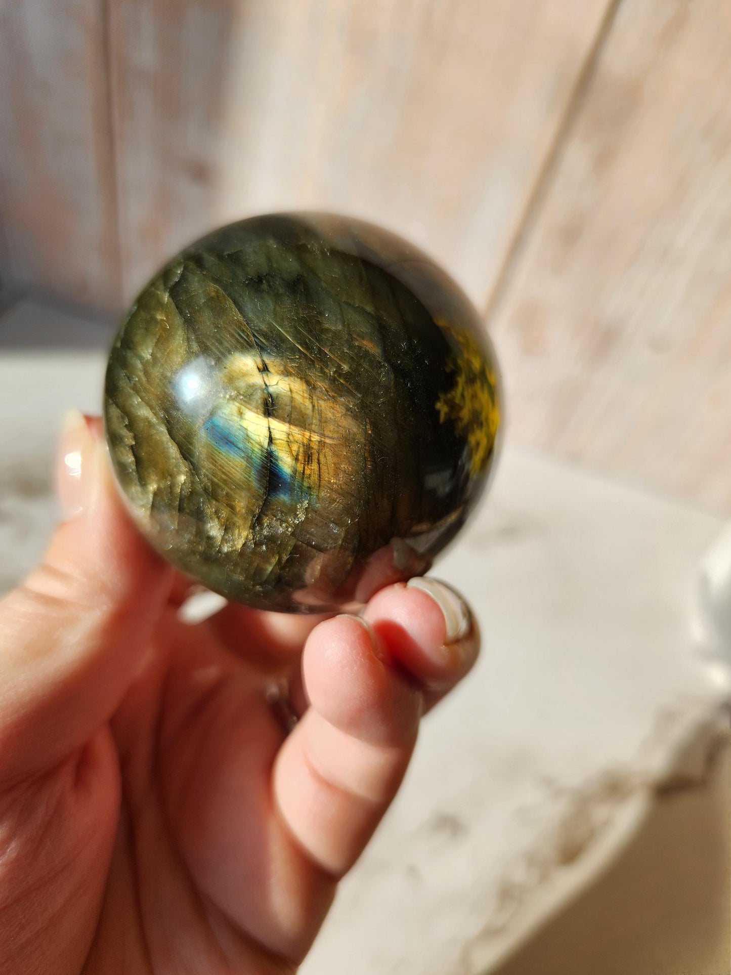 Labradorite sphere with sunset flash