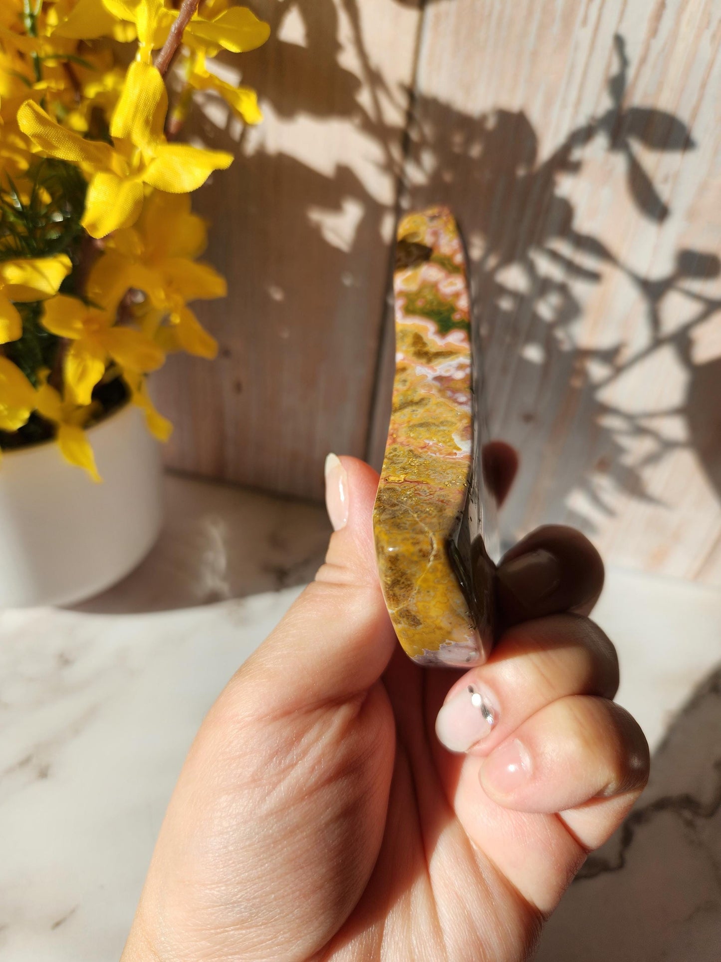 Large pink yellow ocean jasper moon with beautiful colors, patterns, and small sparkly druzy, stand included