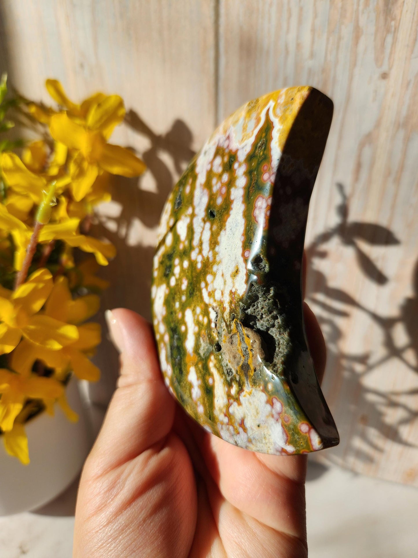 Large pink ocean jasper moon with beautiful colors, patterns, and druzy, stand included