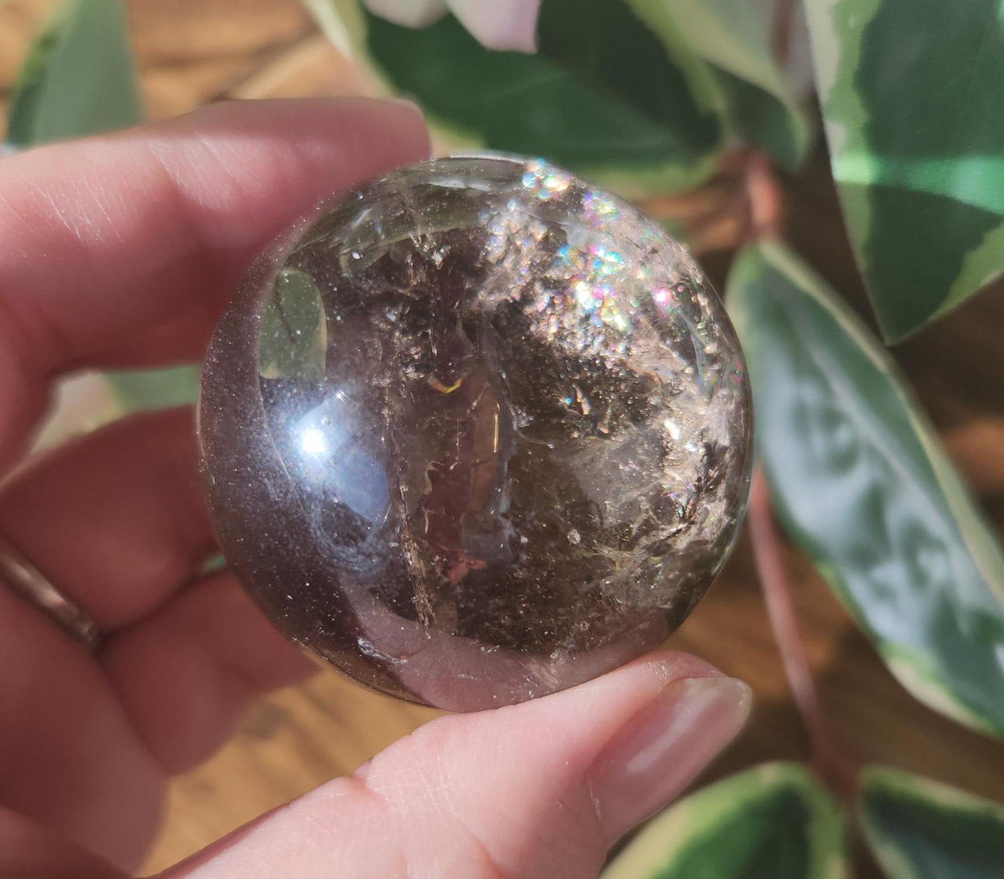 High quality natural smoky quartz sphere with many rainbows and inclusions