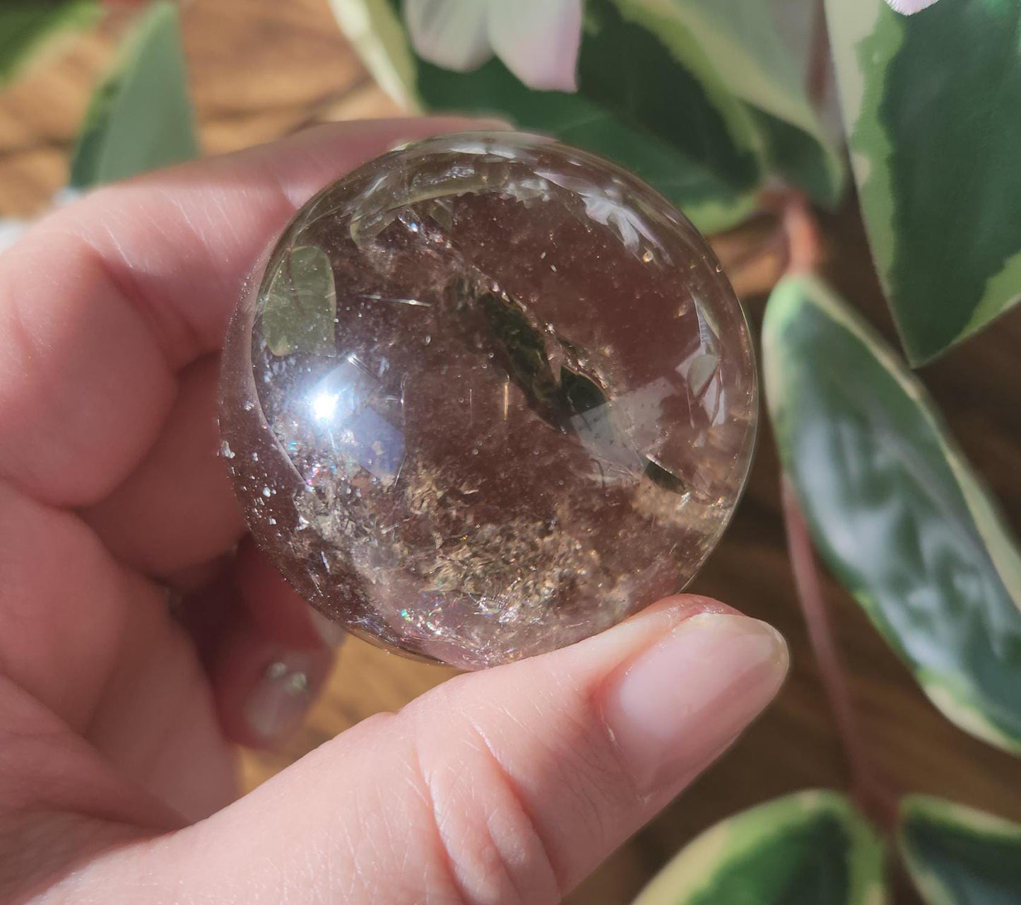 High quality natural smoky quartz sphere with many rainbows and inclusions