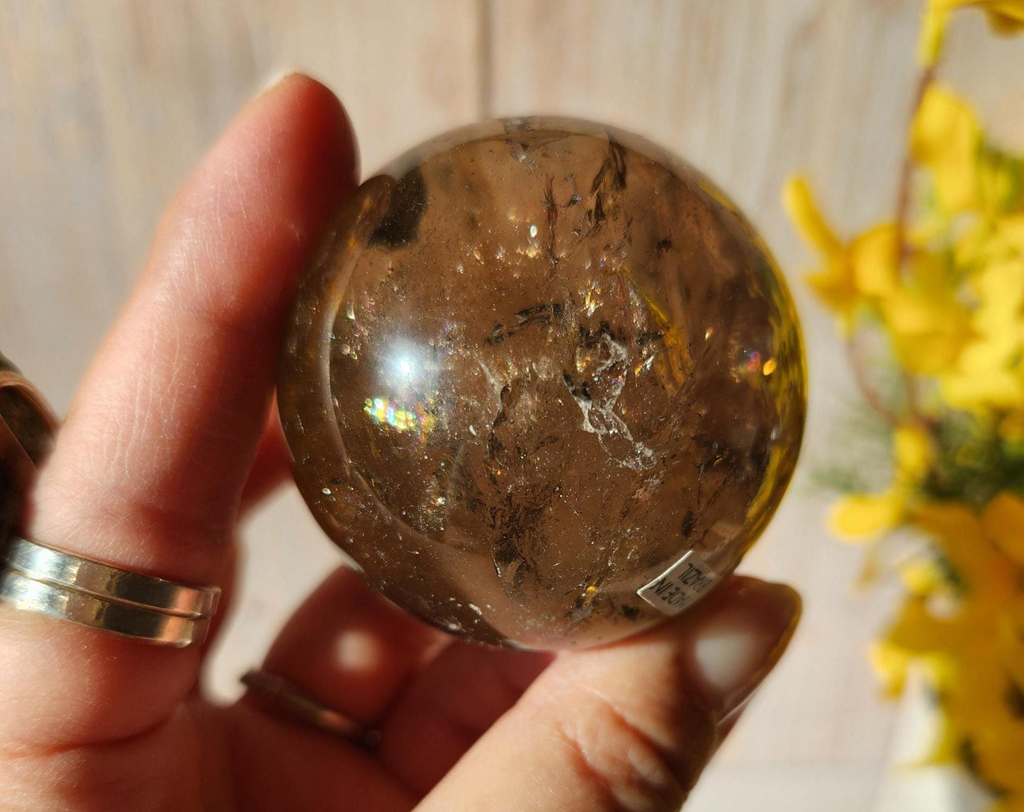 Stunning natural dark smoky quartz sphere with many rainbows and inclusions