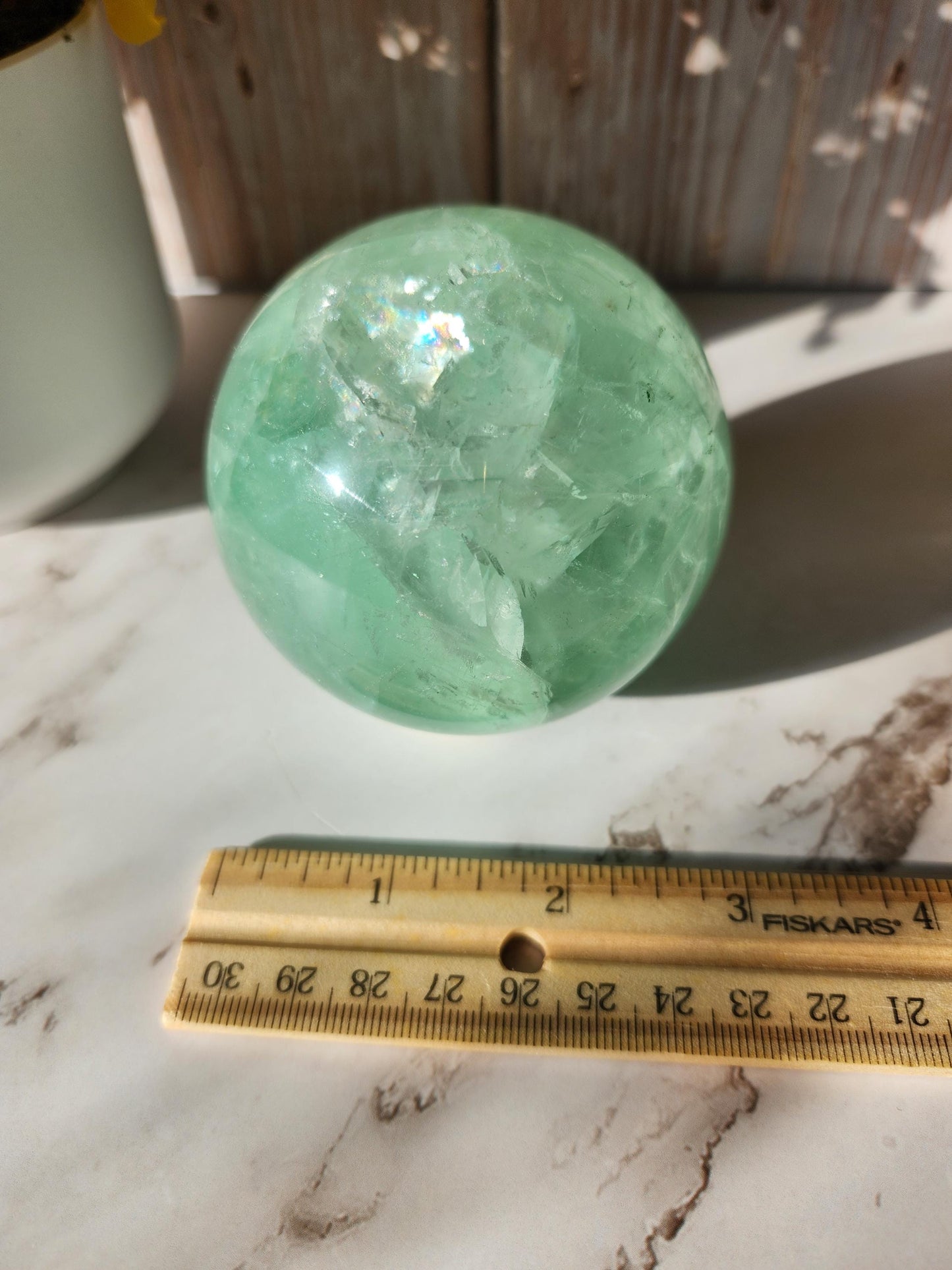 Beautiful large natural green fluorite sphere with many rainbows and inclusions 73.4mm