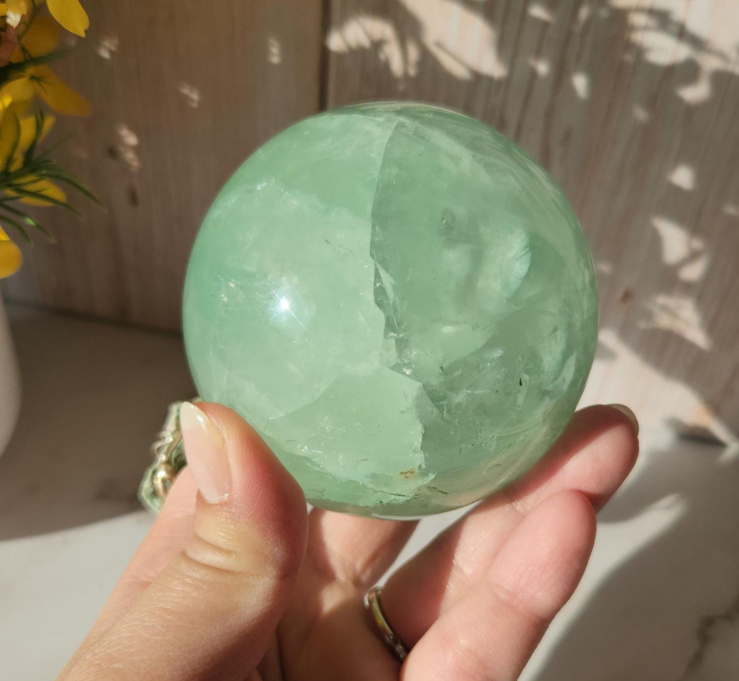 Beautiful large natural green fluorite sphere with many rainbows and inclusions 73.4mm