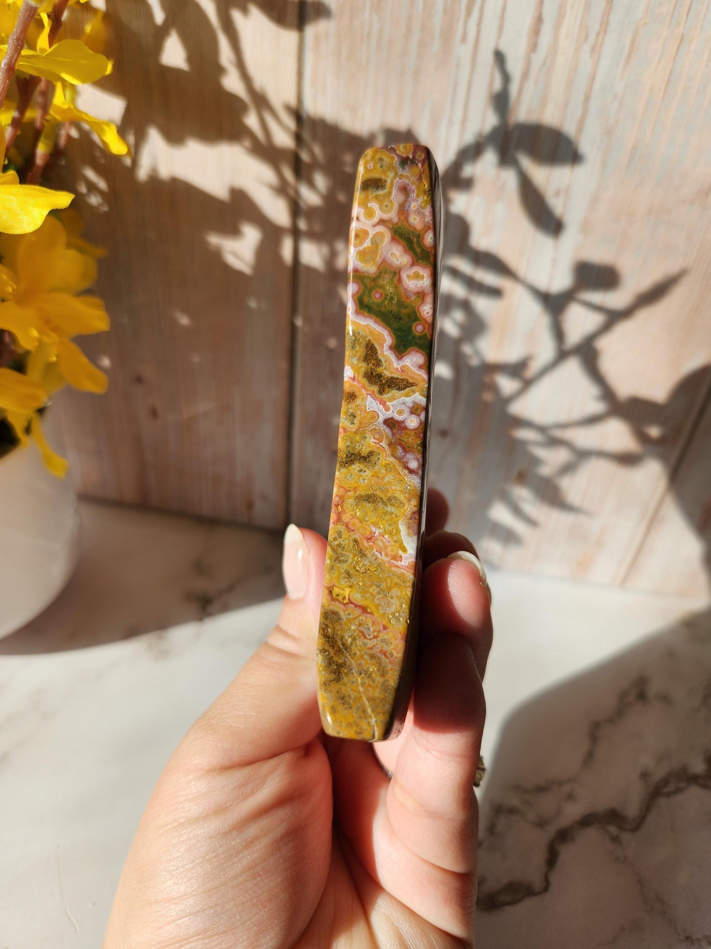 Large pink yellow ocean jasper moon with beautiful colors, patterns, and small sparkly druzy, stand included