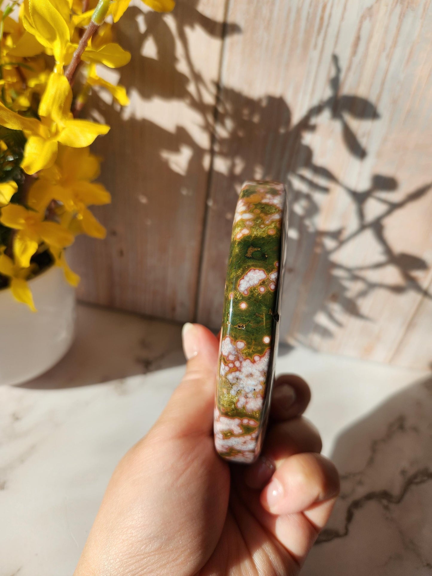 Large pink yellow ocean jasper moon with beautiful colors, patterns, and small sparkly druzy, stand included