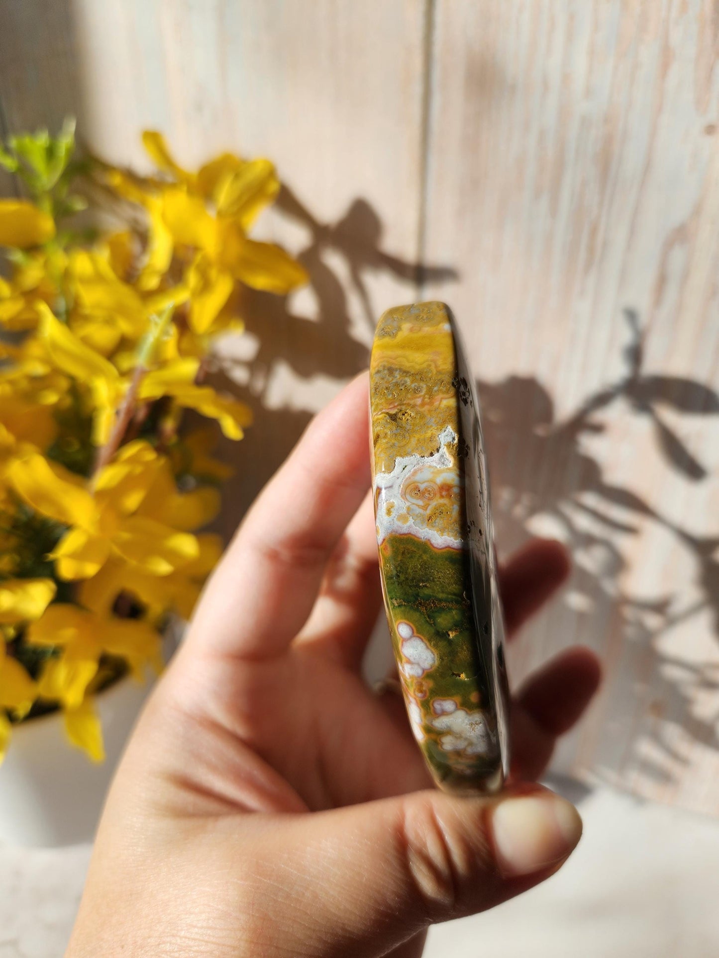 Large pink ocean jasper moon with beautiful colors, patterns, and druzy, stand included