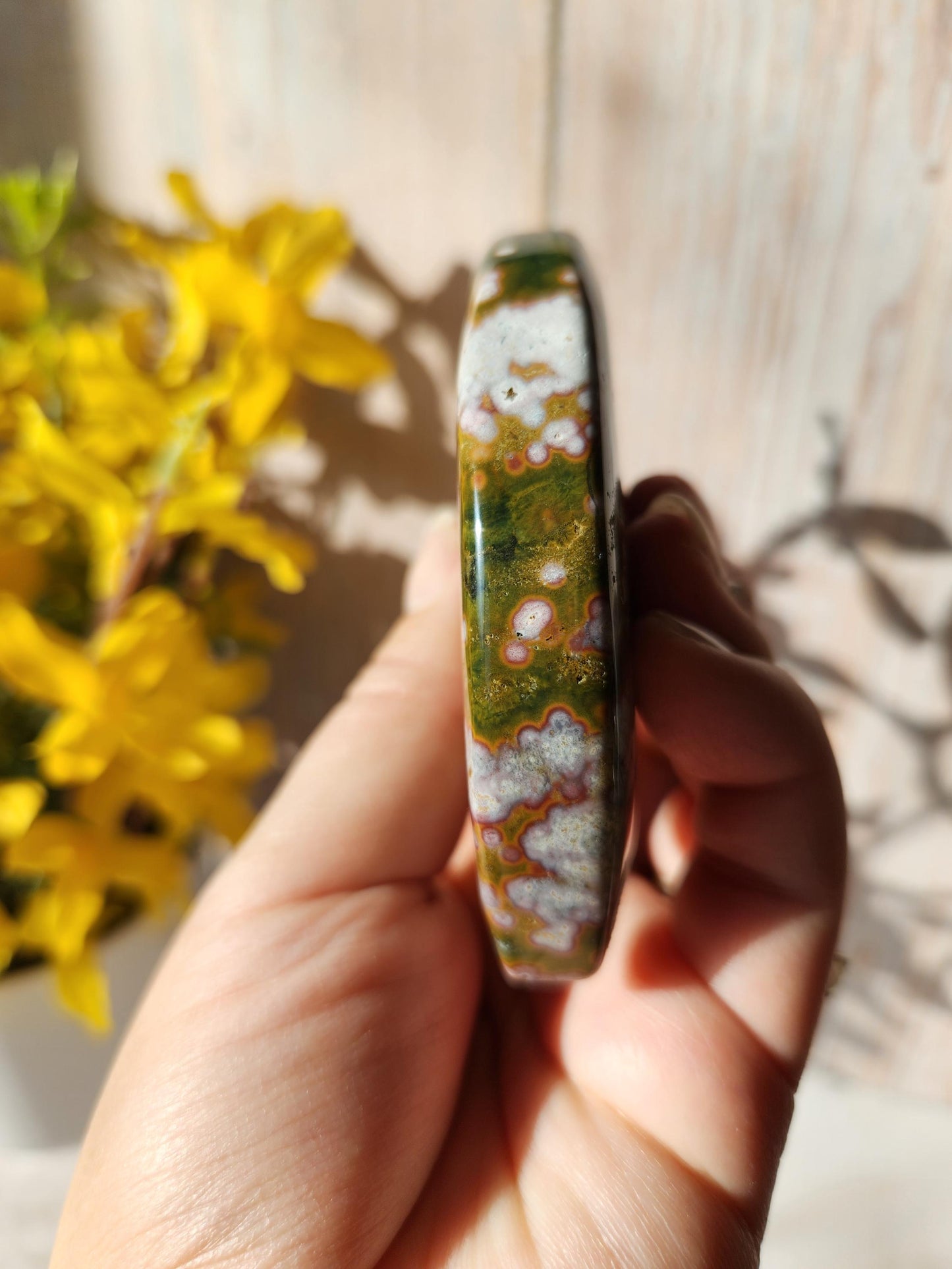 Large pink ocean jasper moon with beautiful colors, patterns, and druzy, stand included