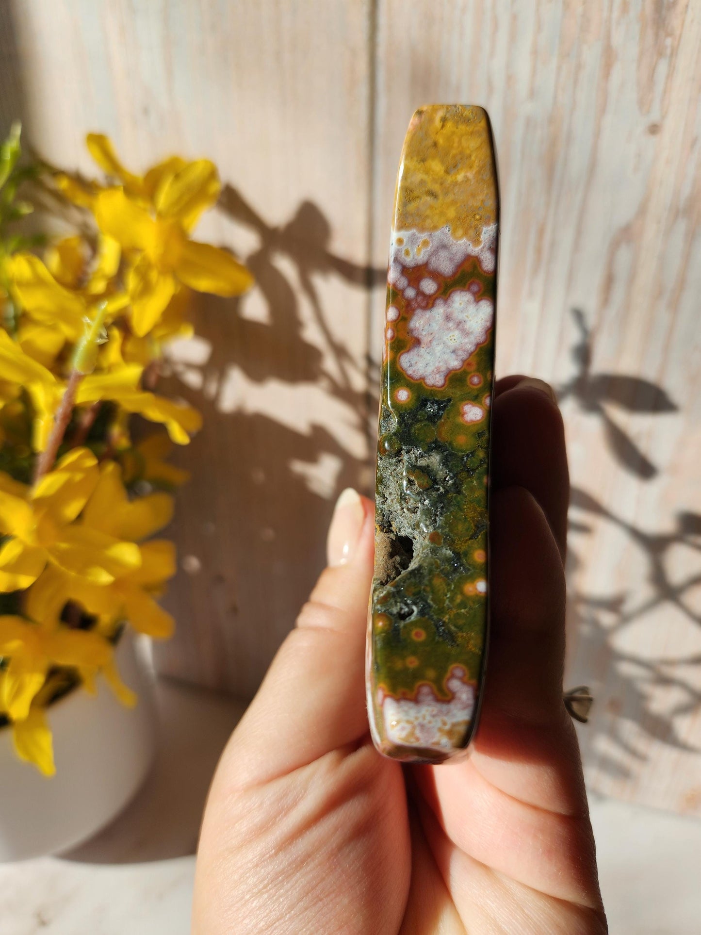 Large pink ocean jasper moon with beautiful colors, patterns, and druzy, stand included