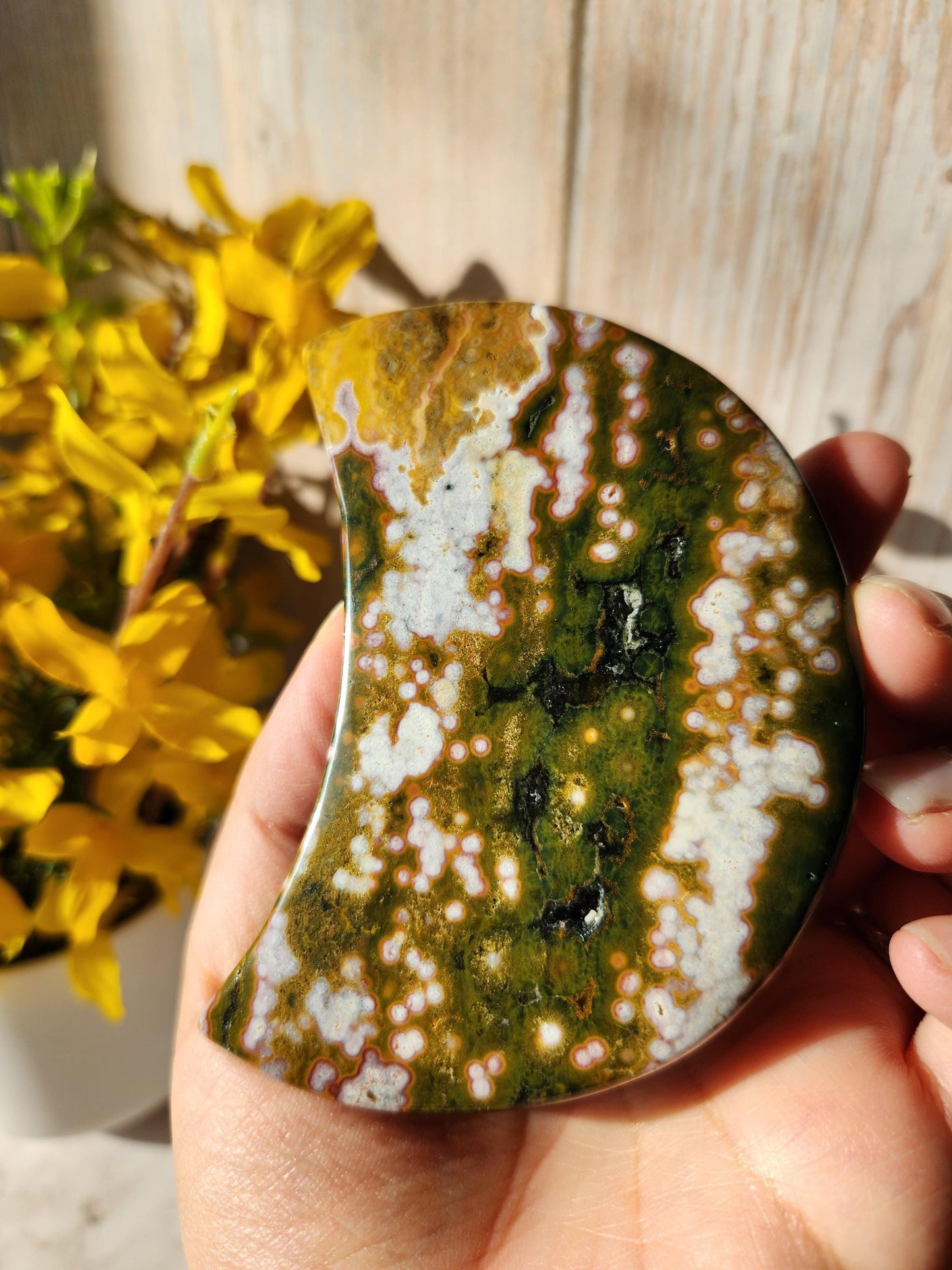 Large pink ocean jasper moon with beautiful colors, patterns, and druzy, stand included