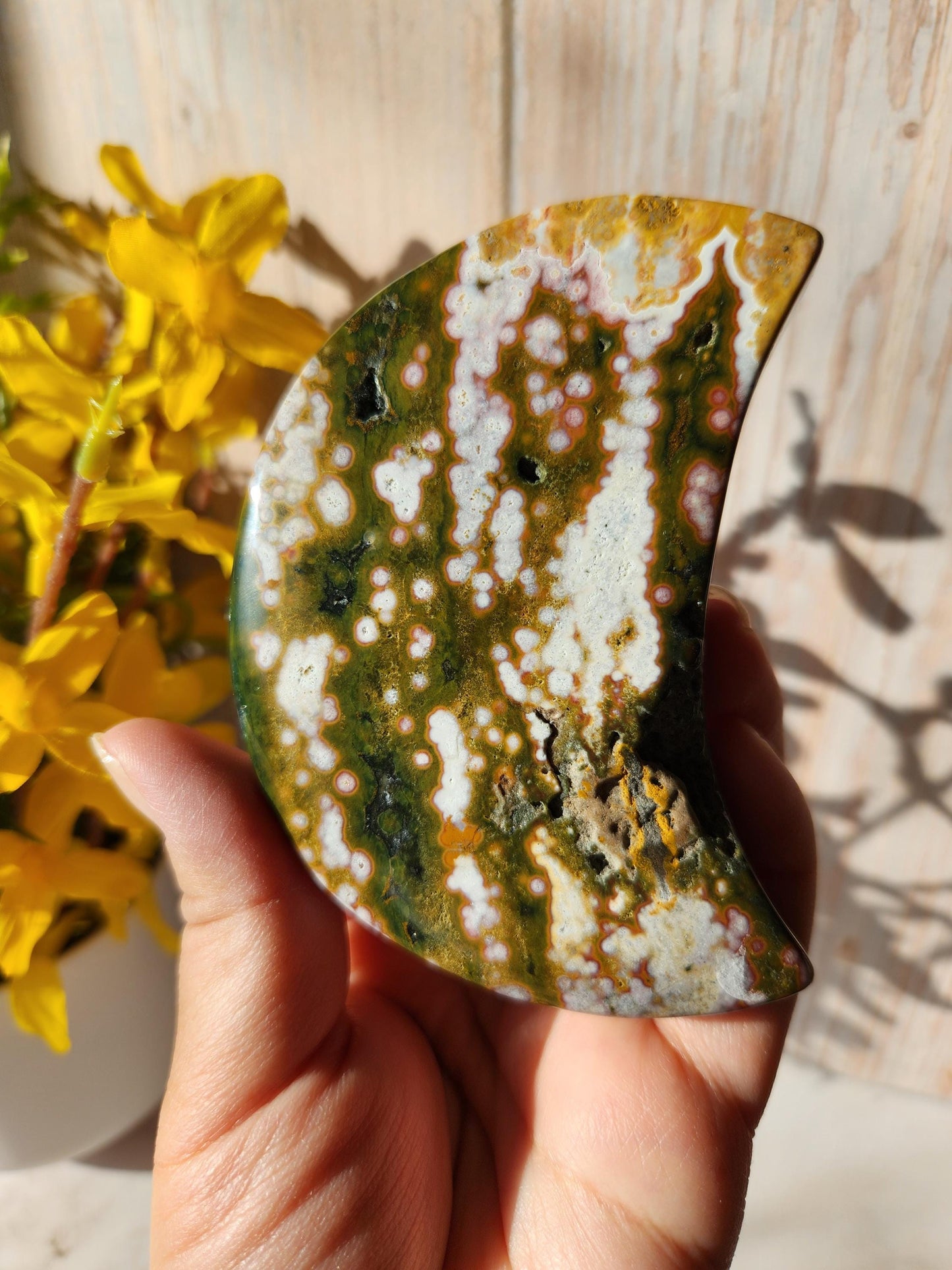 Large pink ocean jasper moon with beautiful colors, patterns, and druzy, stand included