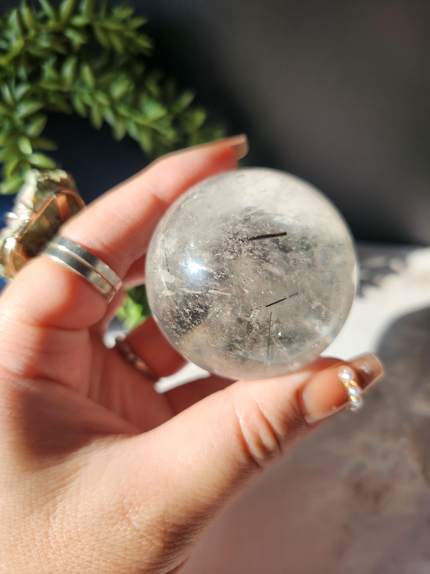 High quality black tourmaline in quartz sphere with rainbows.