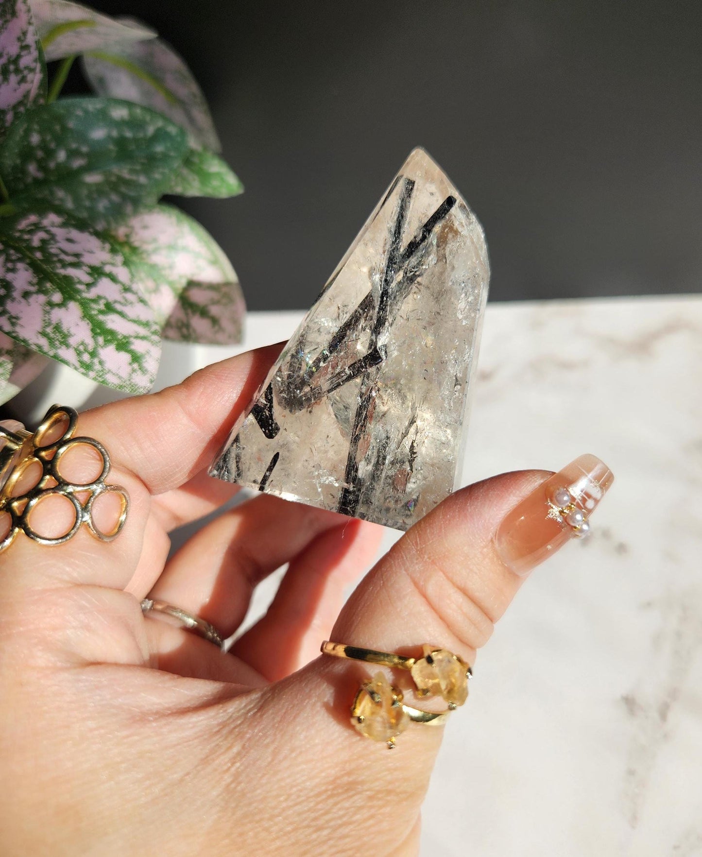 High quality black tourmaline in quartz freefrom with rainbows on a beautiful gold custom stand
