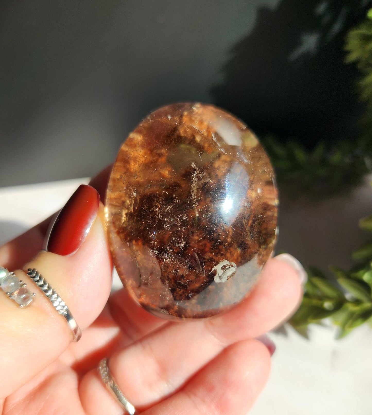 Natural smoky lodolite garden quartz lens from Brazil, half polish and half raw, with a beautiful rainbow