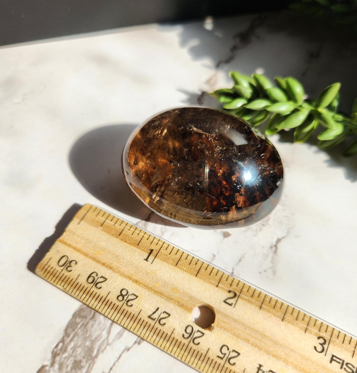 Natural smoky lodolite garden quartz lens from Brazil, half polish and half raw, with a beautiful rainbow