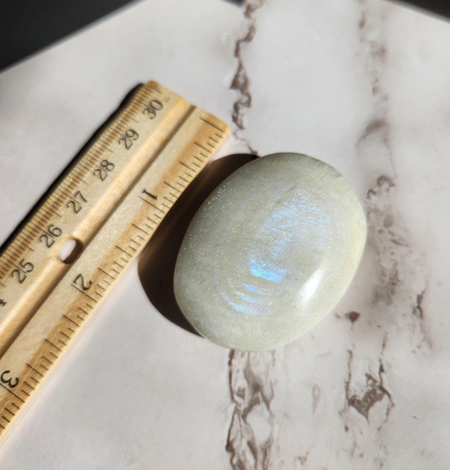 High quality blue moonstone palm stone with white and blue flash from Madagascar A24