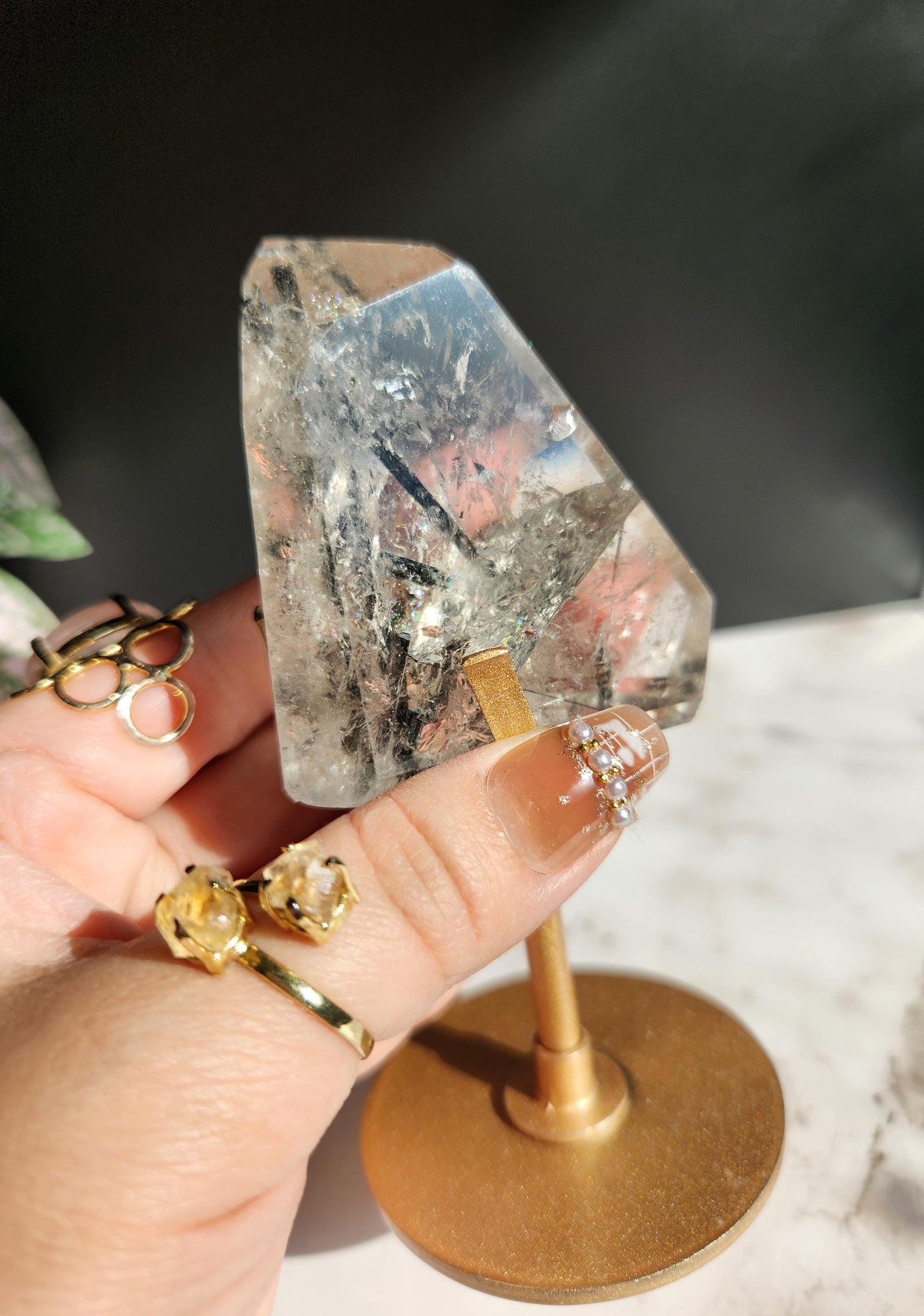 High quality black tourmaline in quartz freefrom with rainbows on a beautiful gold custom stand