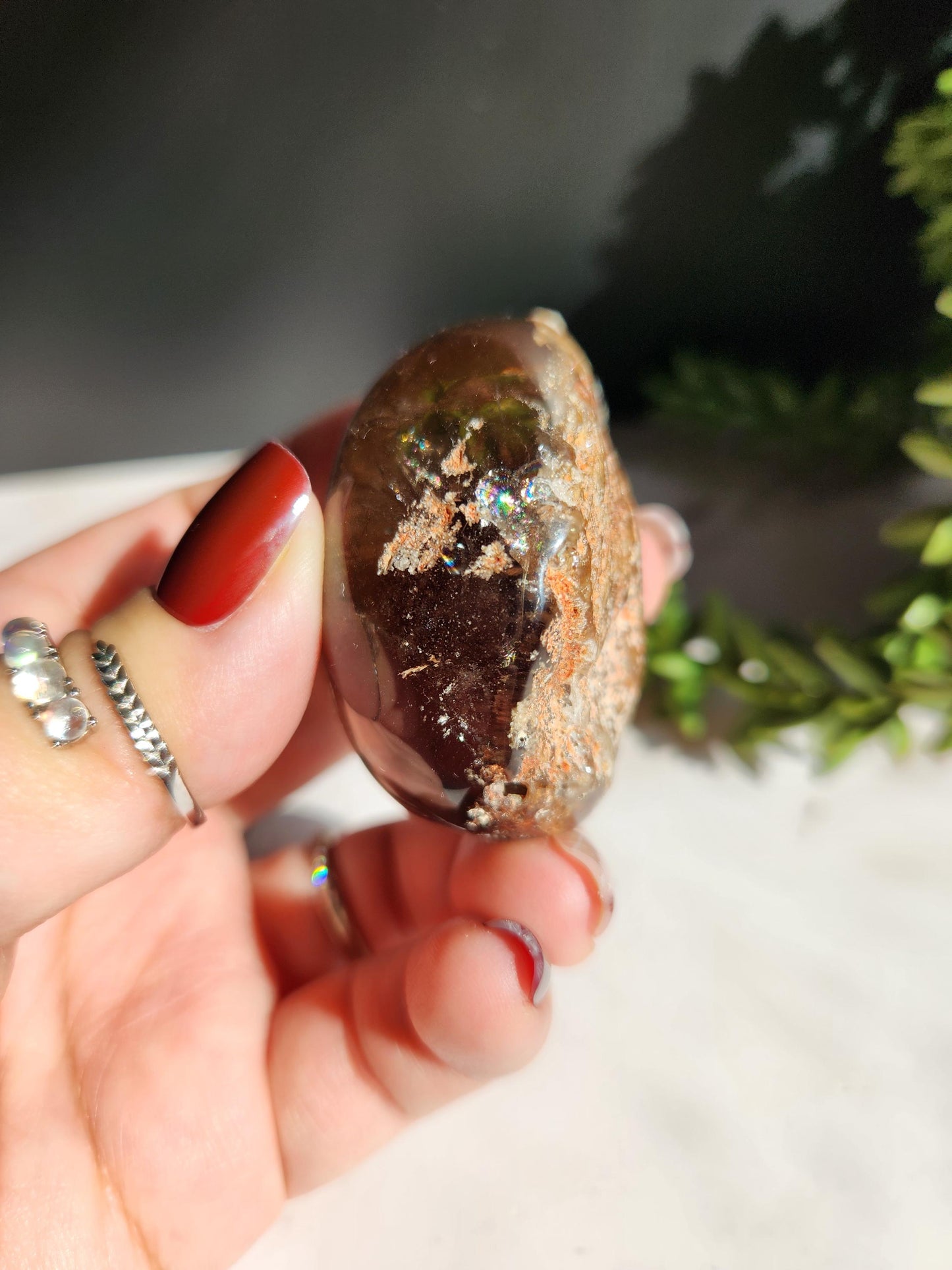 Natural smoky lodolite garden quartz lens from Brazil, half polish and half raw, with a beautiful rainbow