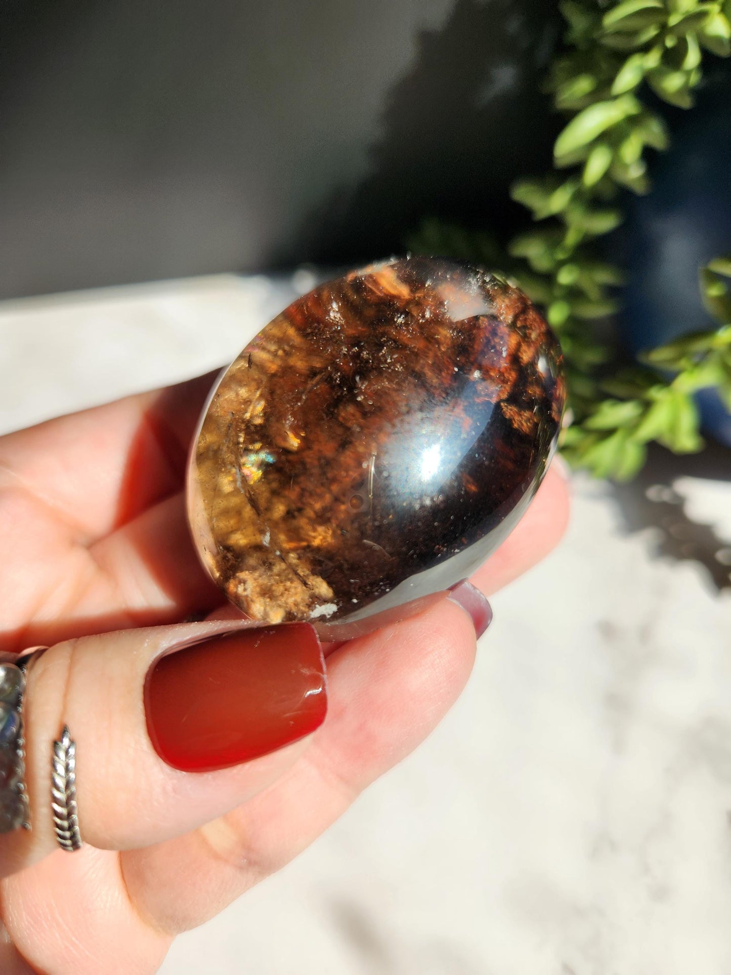 Natural smoky lodolite garden quartz lens from Brazil, half polish and half raw, with a beautiful rainbow