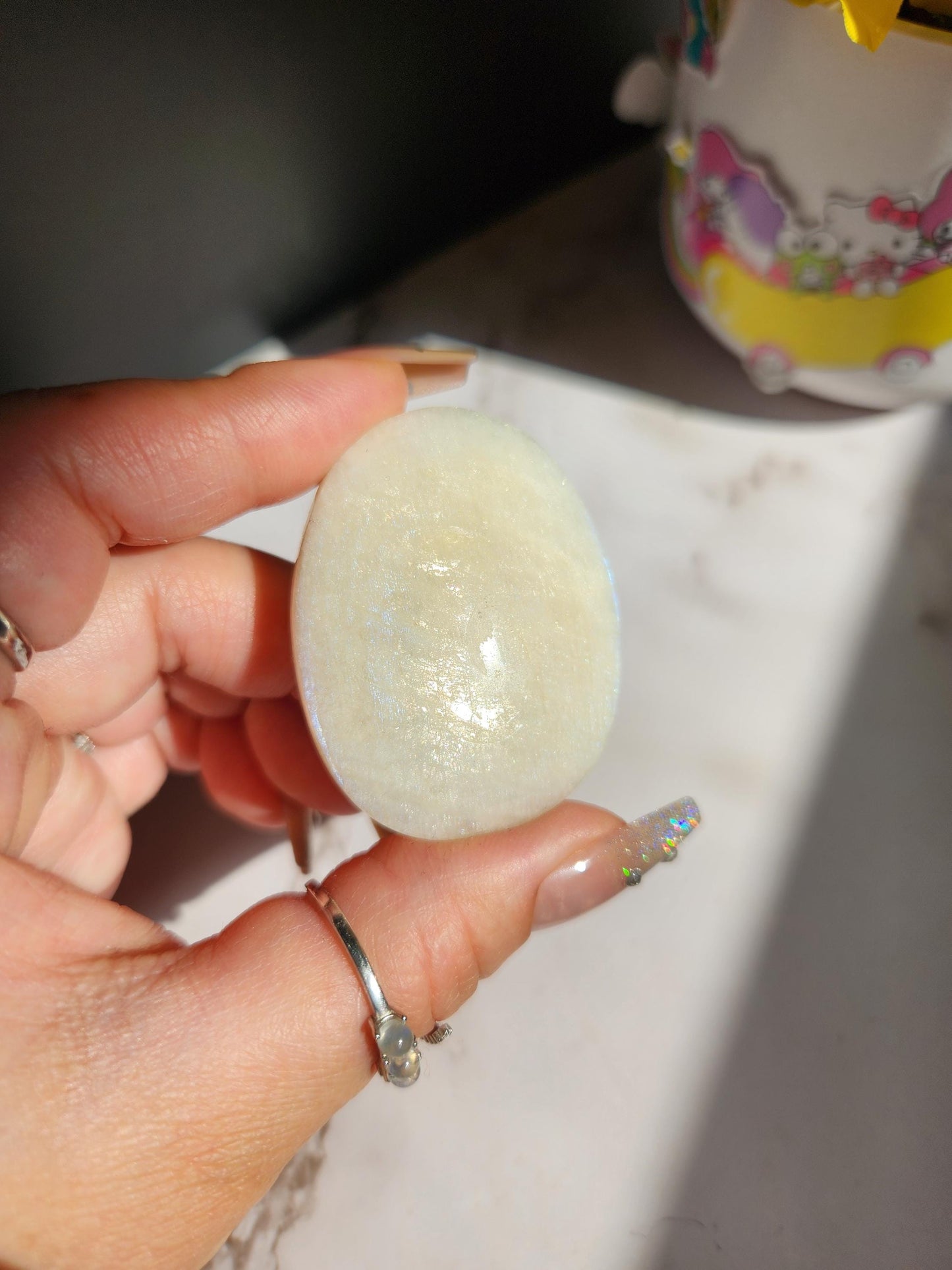 High quality blue moonstone palm stone with white and blue flash from Madagascar A24