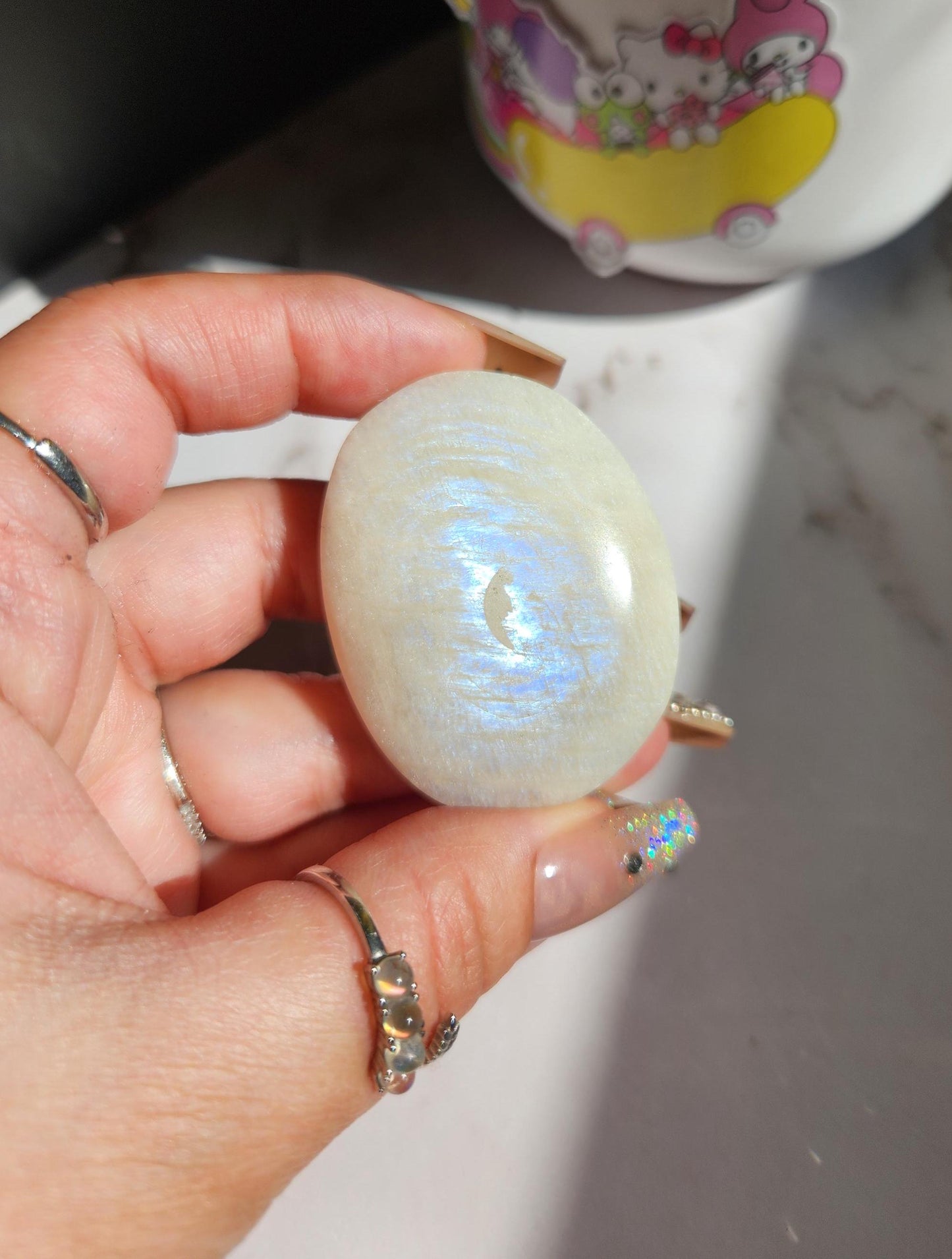 High quality blue moonstone palm stone with white and blue flash from Madagascar A24