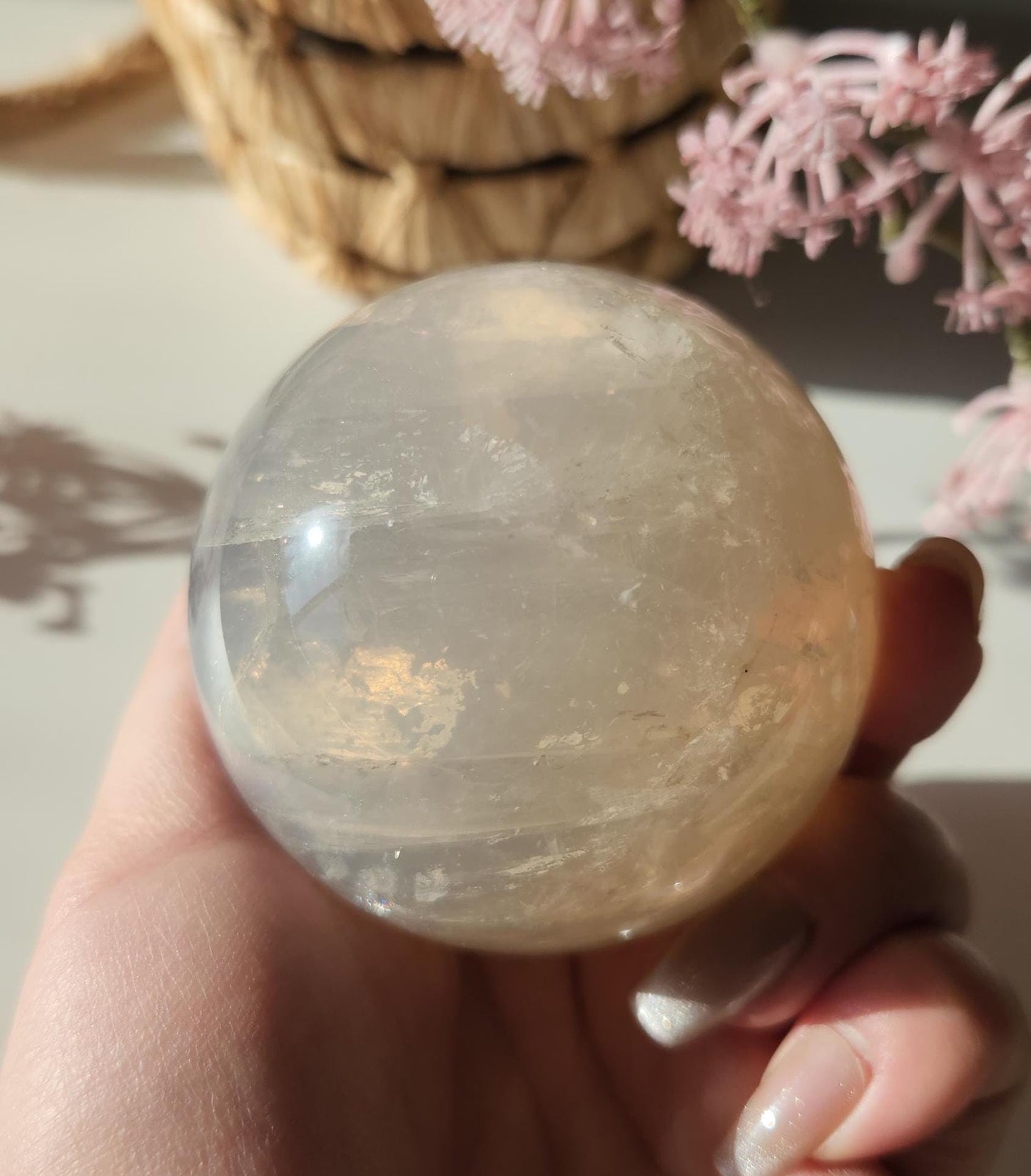 Beautiful blue rose quartz sphere with inclusions and rainbows