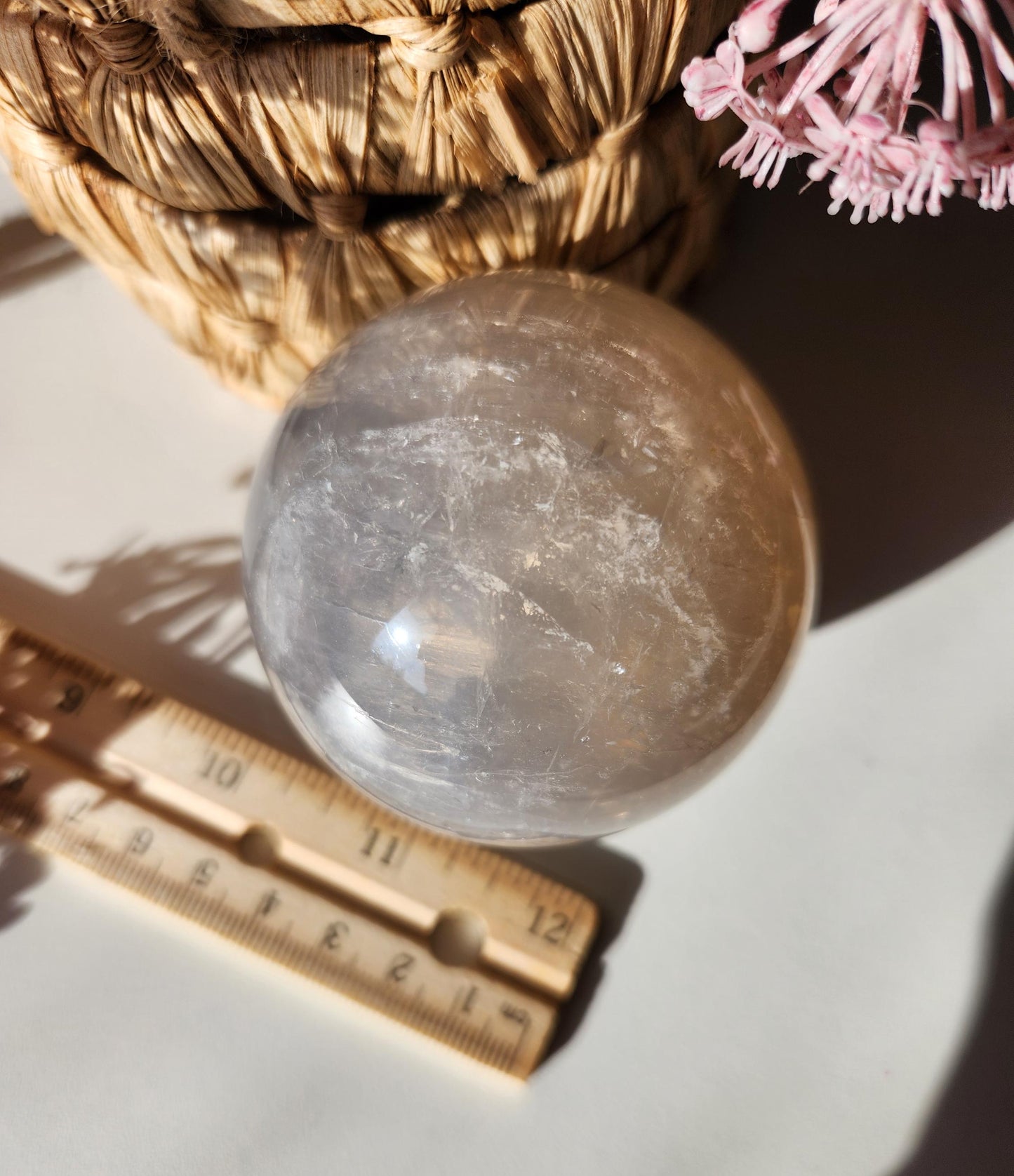 Beautiful blue rose quartz sphere with inclusions and rainbows