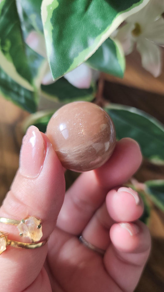 Pretty peach moonstone sphere with a nice flash