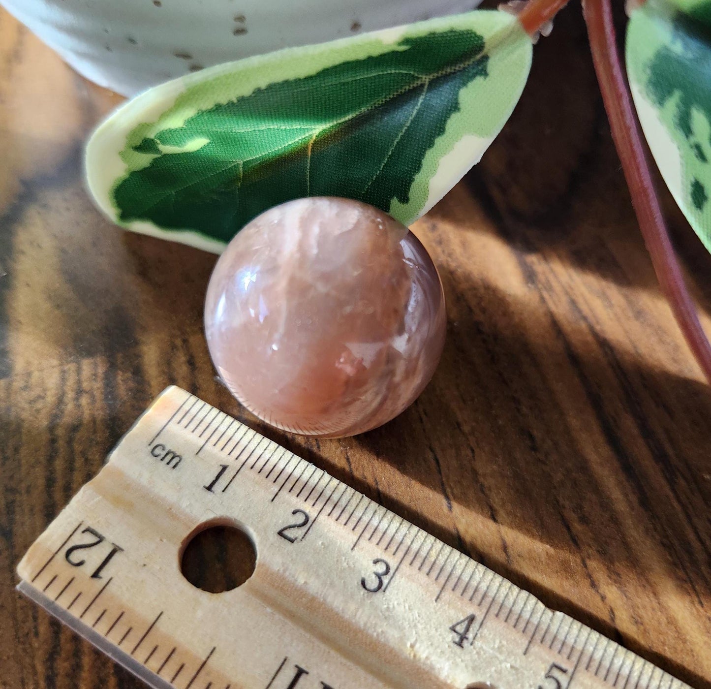 Pretty peach moonstone sphere with a nice flash