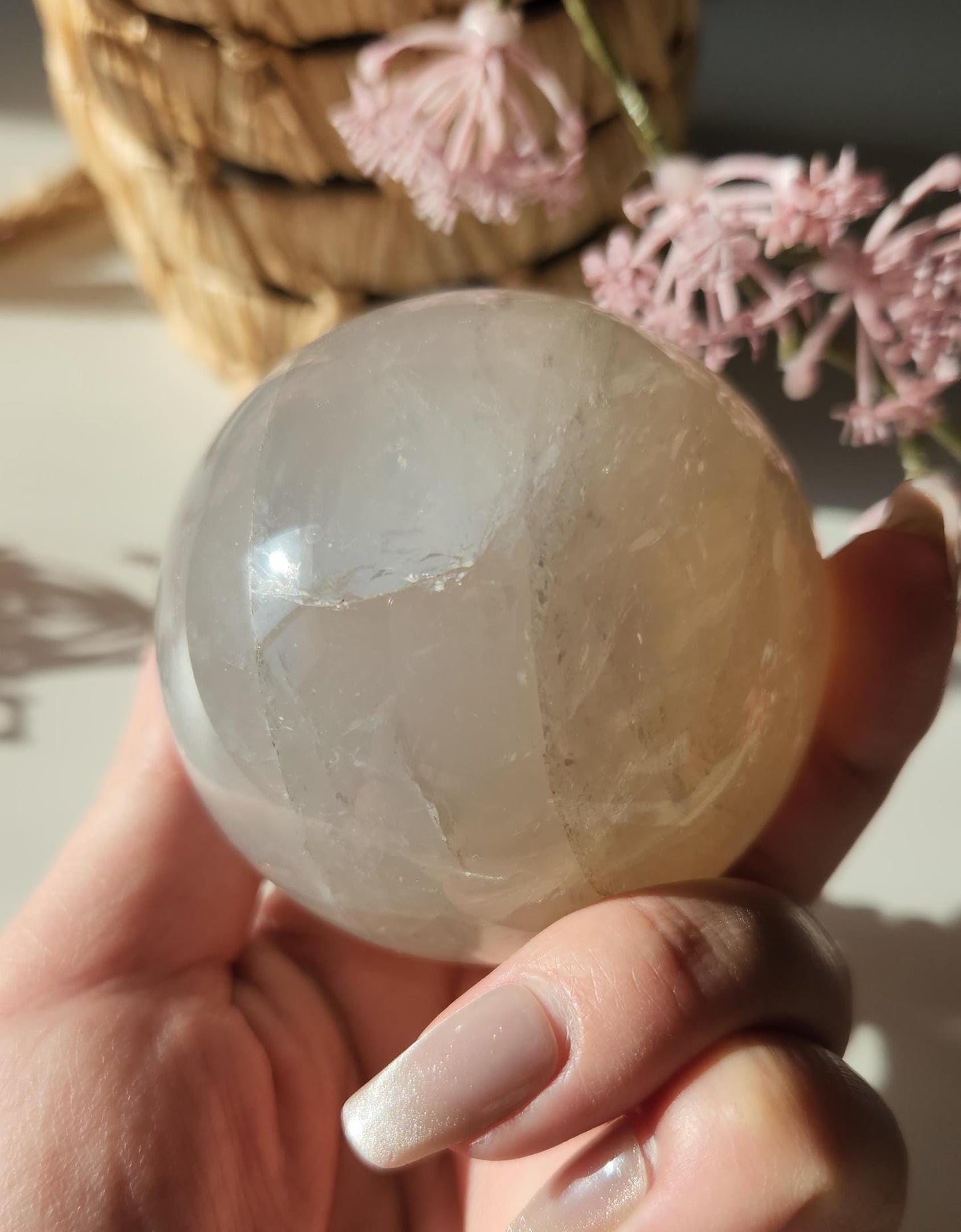 Beautiful blue rose quartz sphere with inclusions and rainbows
