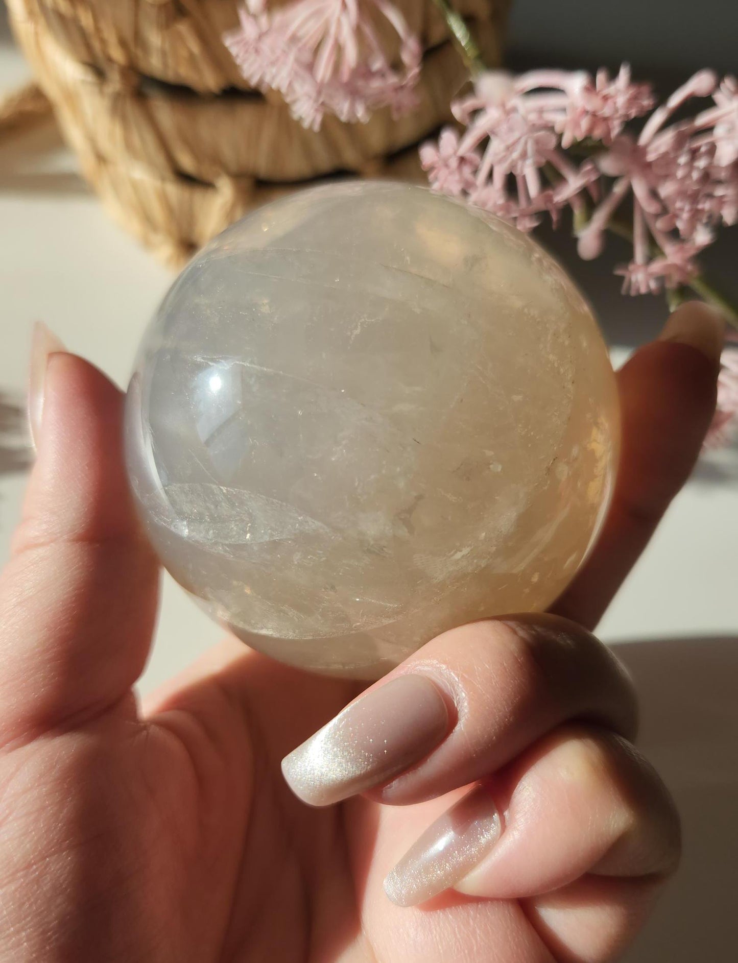 Beautiful blue rose quartz sphere with inclusions and rainbows