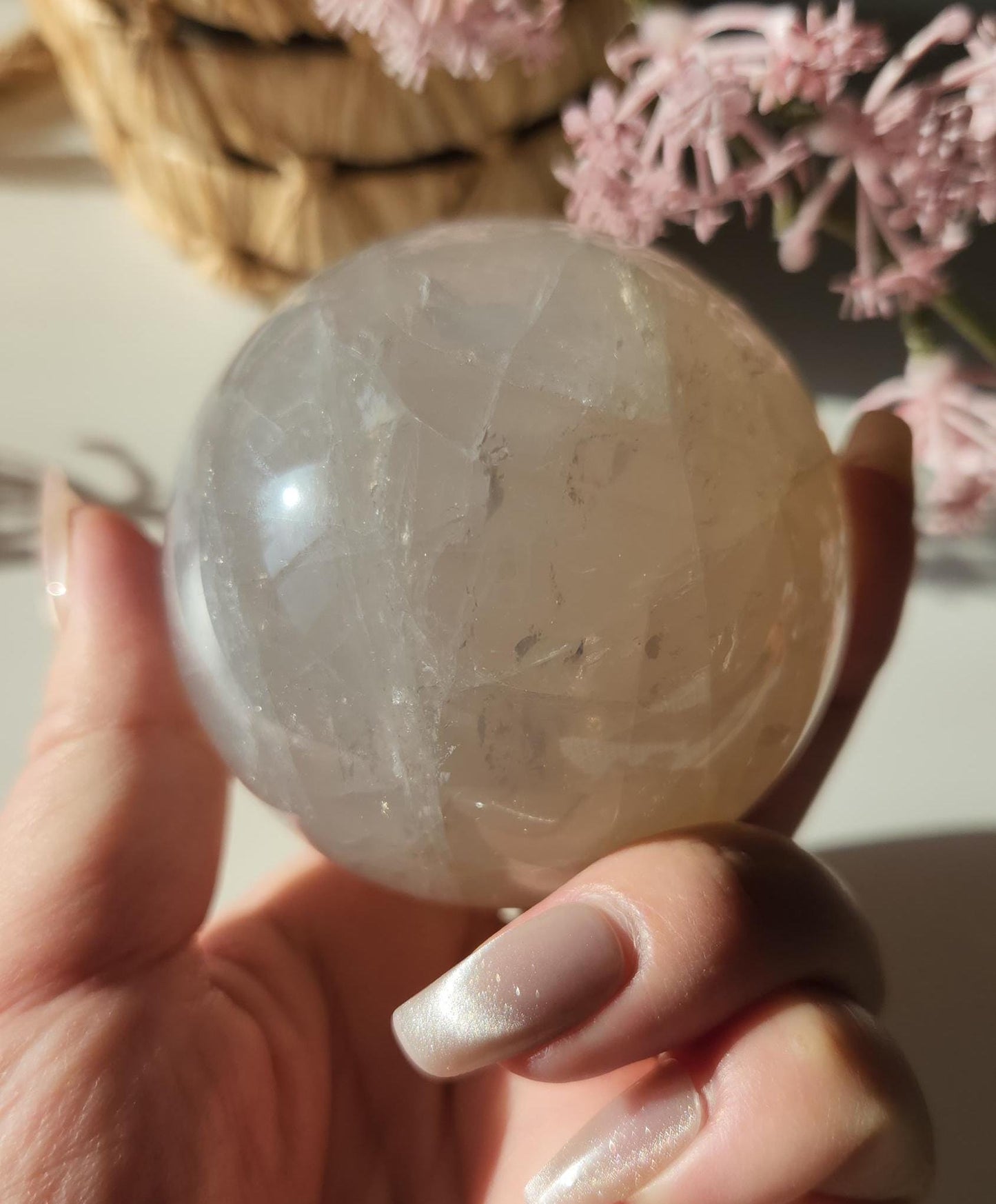 Beautiful blue rose quartz sphere with inclusions and rainbows