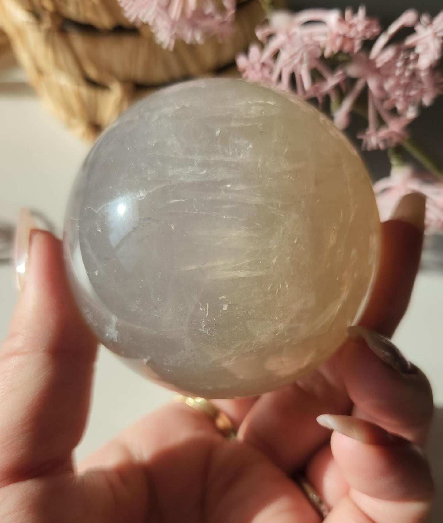 Beautiful blue rose quartz sphere with inclusions and rainbows