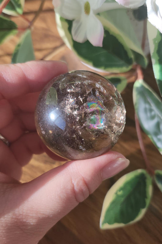 High quality natural smoky quartz sphere with many rainbows and inclusions