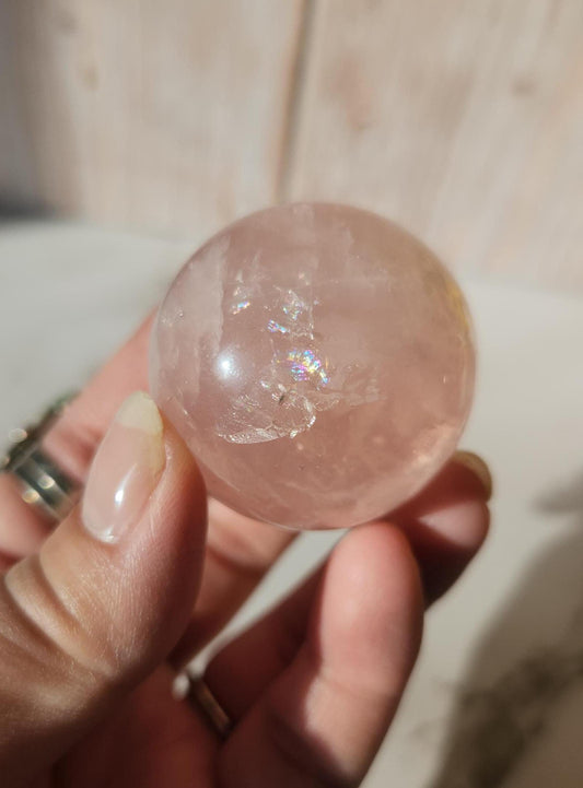 Juicy rose quartz sphere with inclusions, rainbows, and asterism from Brazil  38.5mm